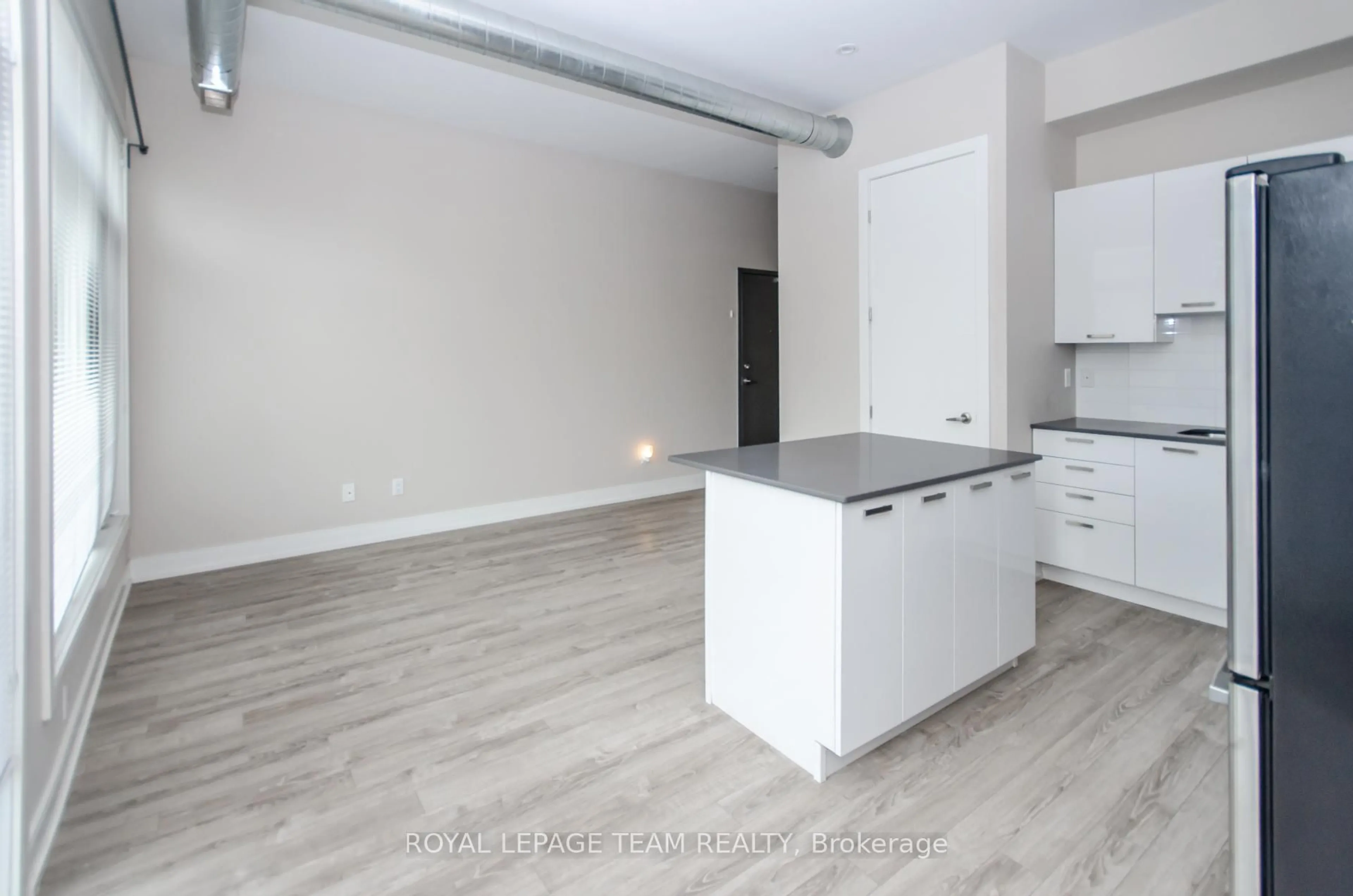 Open concept kitchen, wood/laminate floor for 81 NORMAN St, Ottawa Ontario K1S 3K3