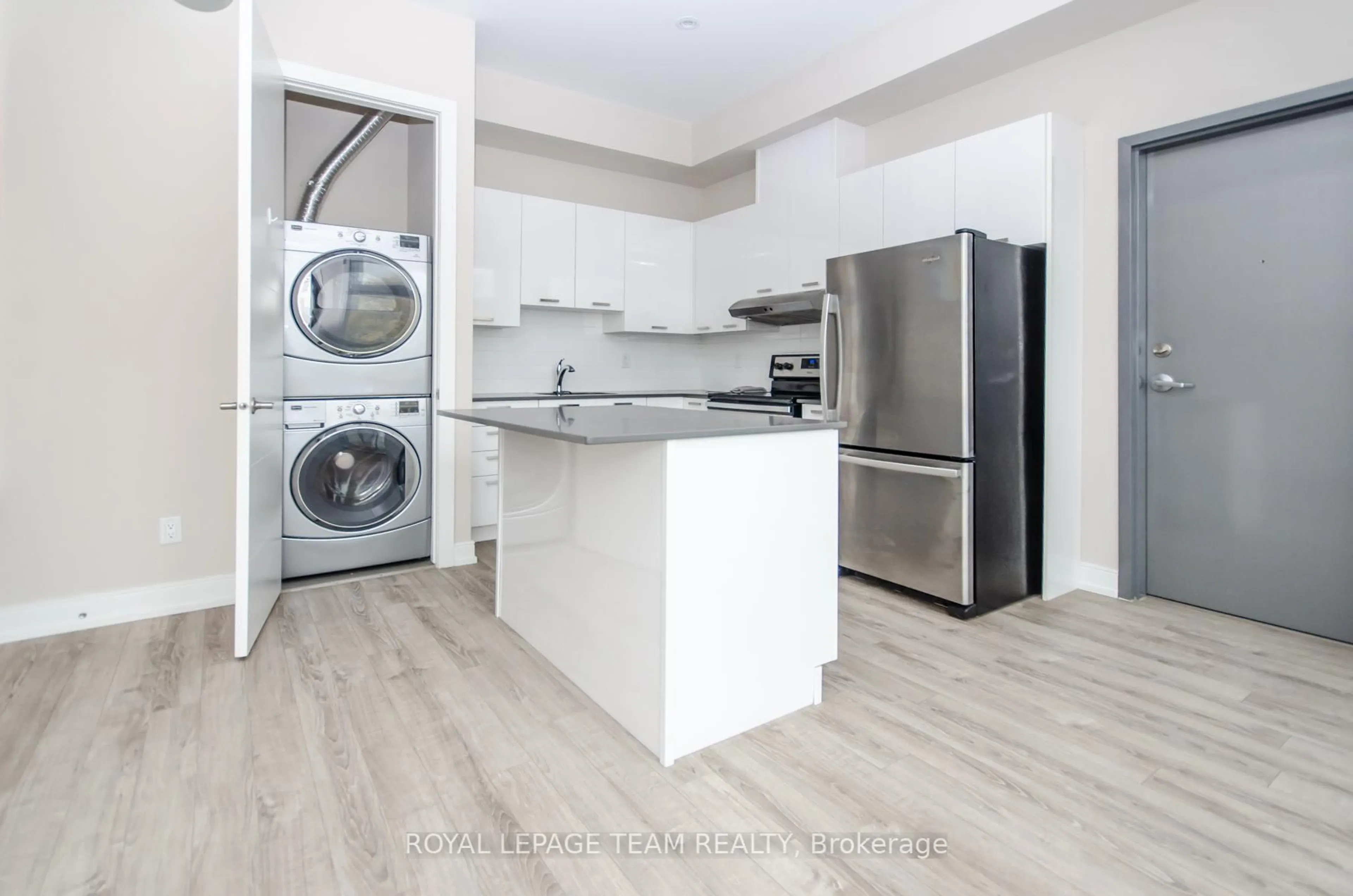 Kitchen with laundary machines, wood/laminate floor for 81 NORMAN St, Ottawa Ontario K1S 3K3