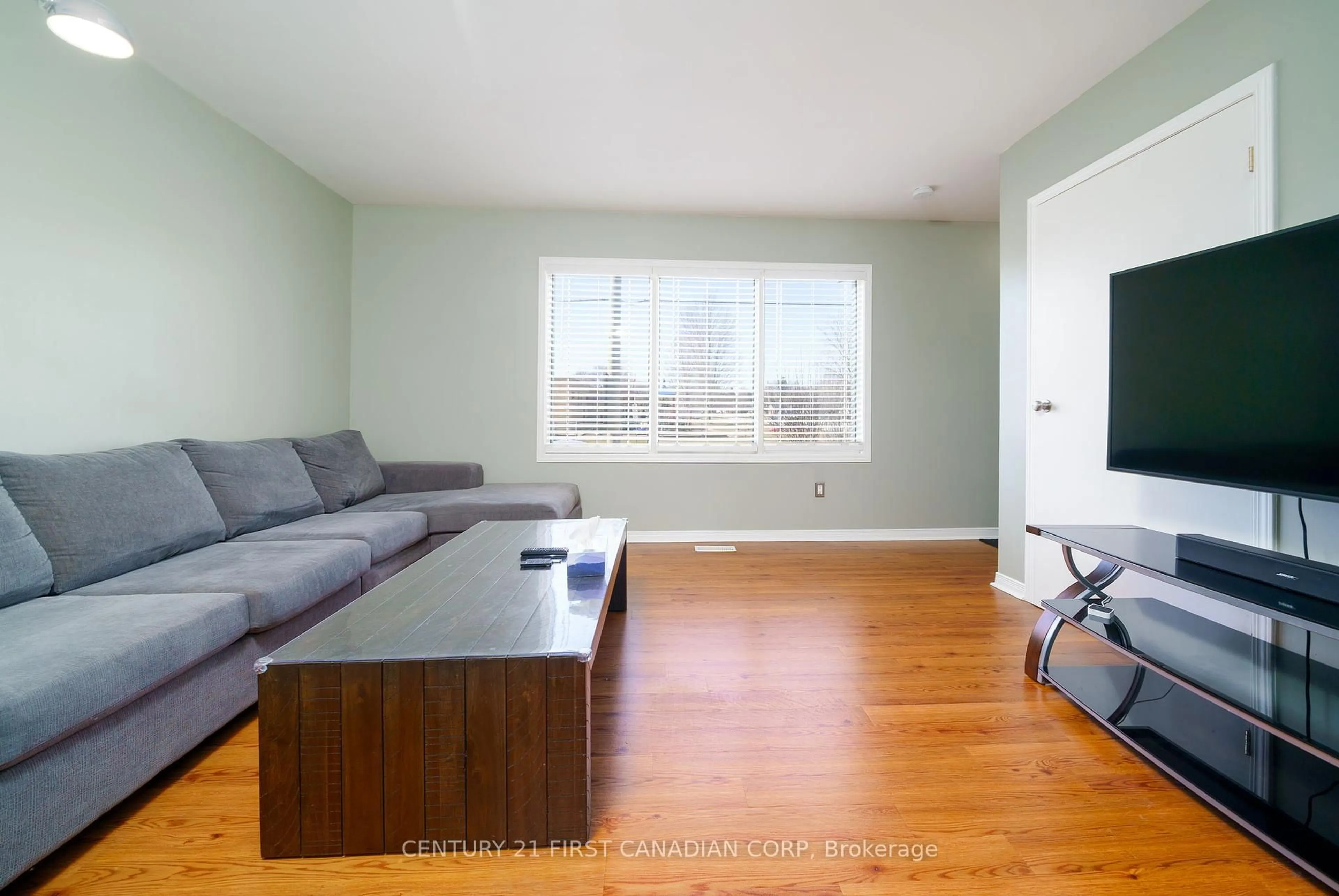 Living room with furniture, wood/laminate floor for 215 Beattie St, Strathroy-Caradoc Ontario N7G 2X3