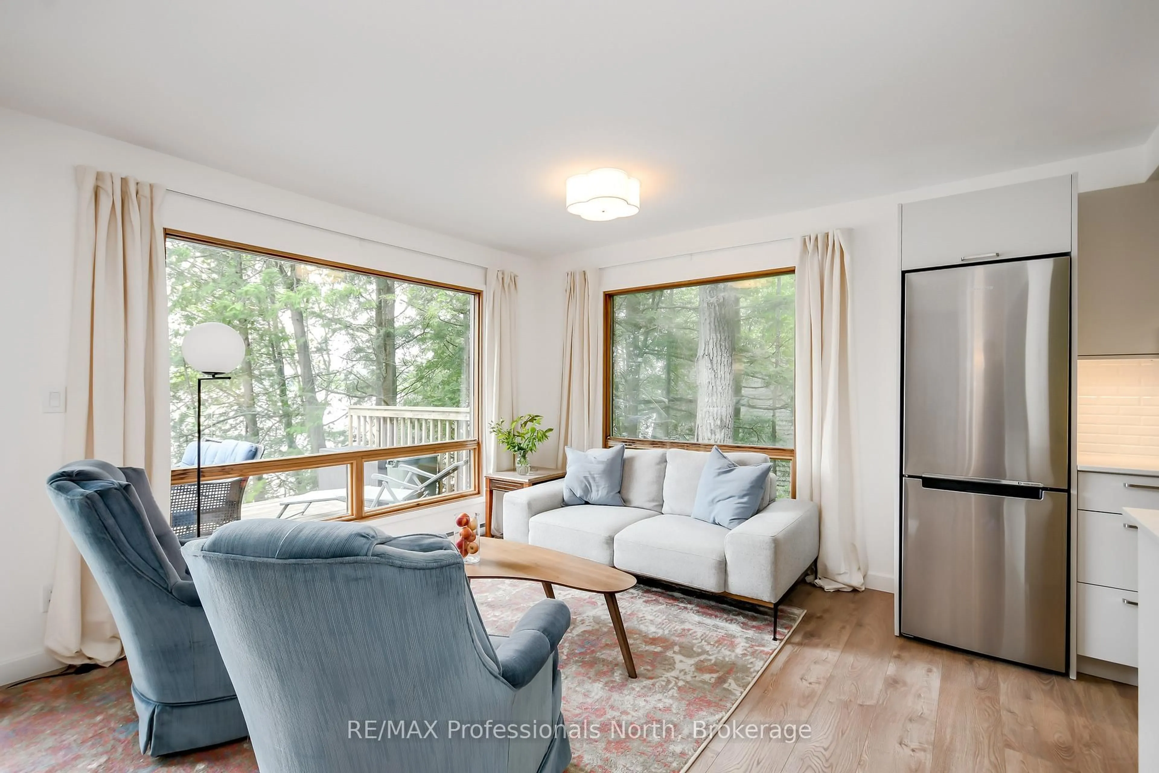 Living room with furniture, wood/laminate floor for 1158 Shea Rd #23, Muskoka Lakes Ontario P0B 1M0