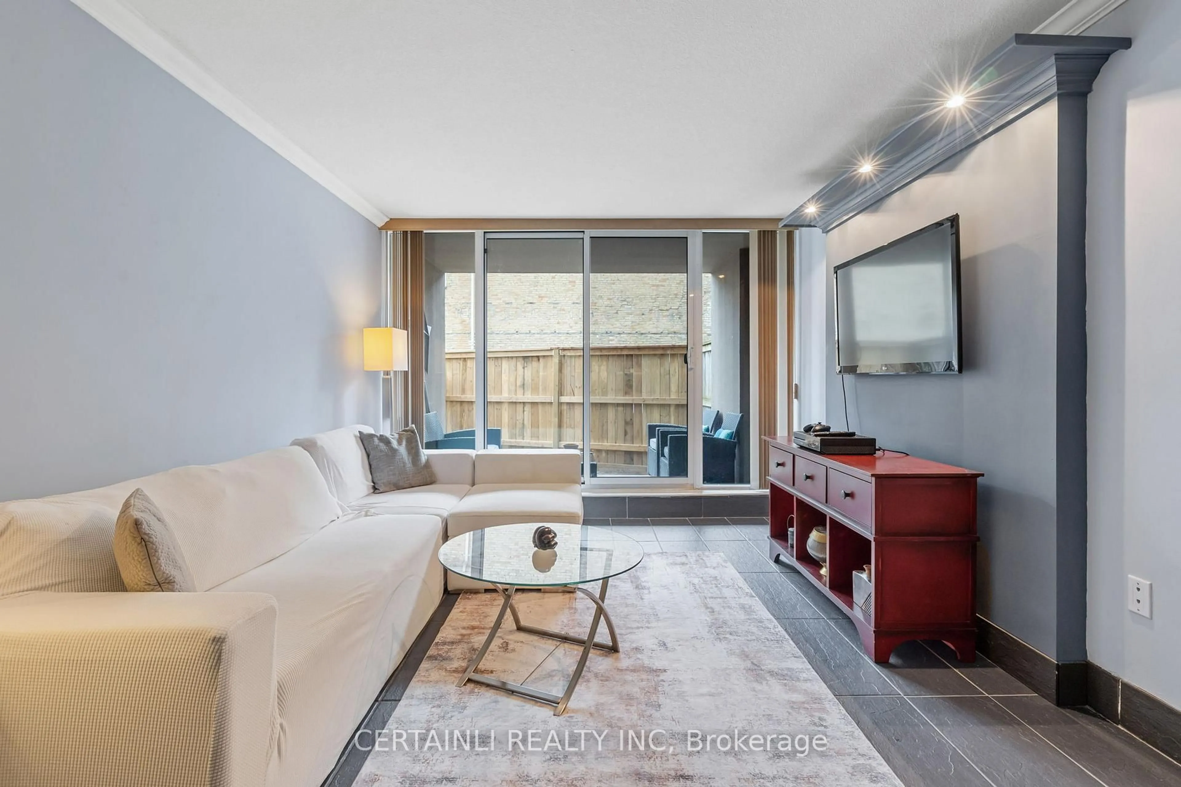 Living room with furniture, wood/laminate floor for 155 Kent St #106, London East Ontario N6A 5N7