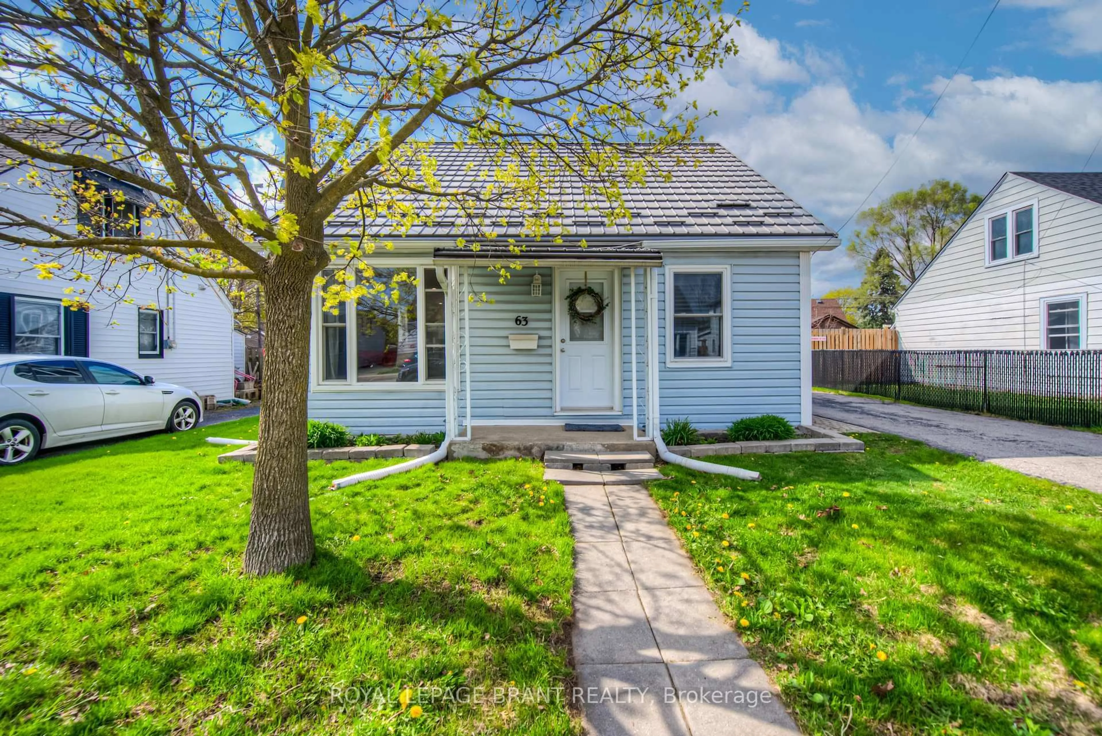Home with vinyl exterior material, street for 63 Tenth Ave, Brantford Ontario N3S 1G3