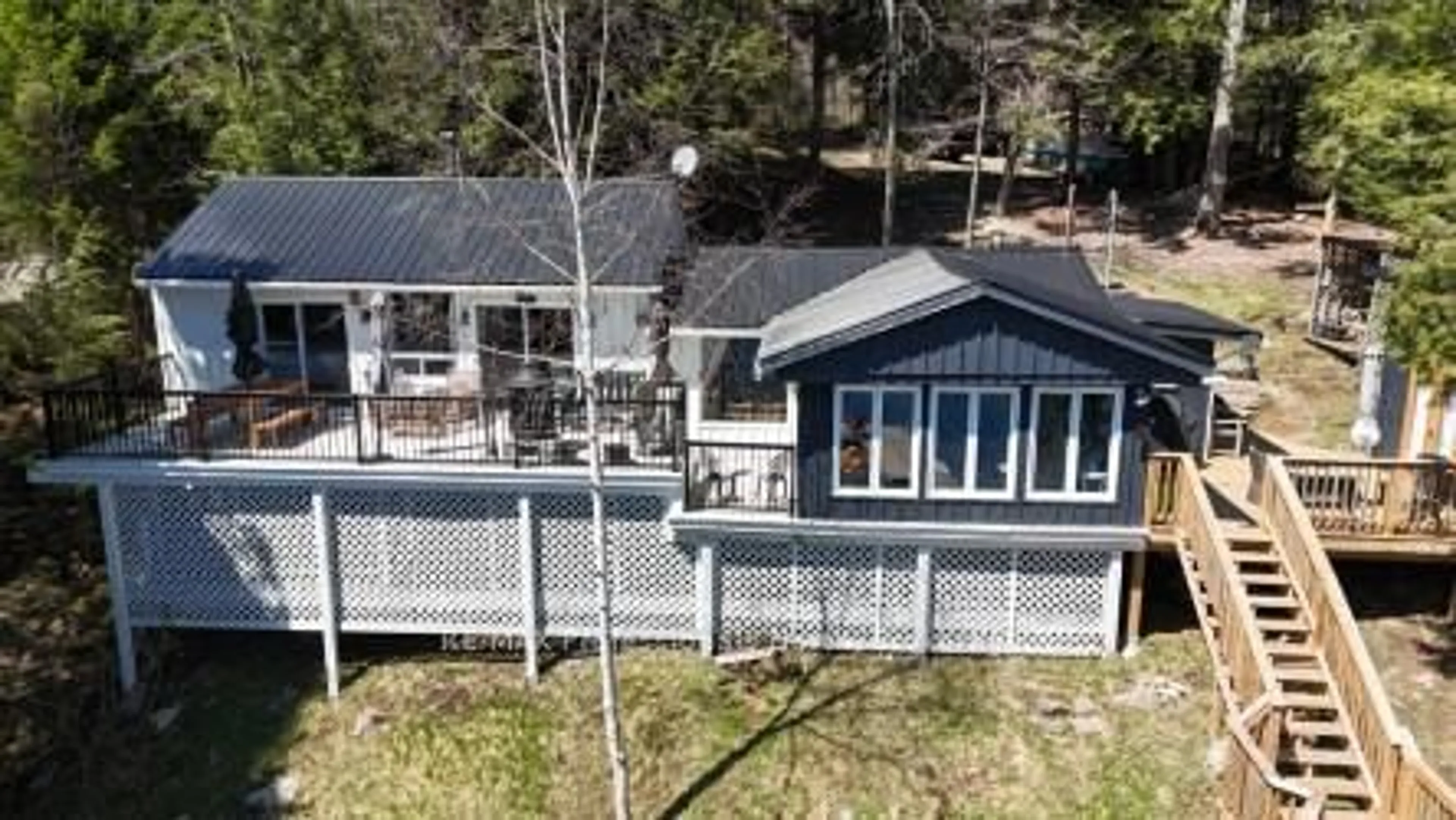 A pic from outside/outdoor area/front of a property/back of a property/a pic from drone, water/lake/river/ocean view for 1352 Bitter Lake Rd, Dysart et al Ontario K0M 2S0