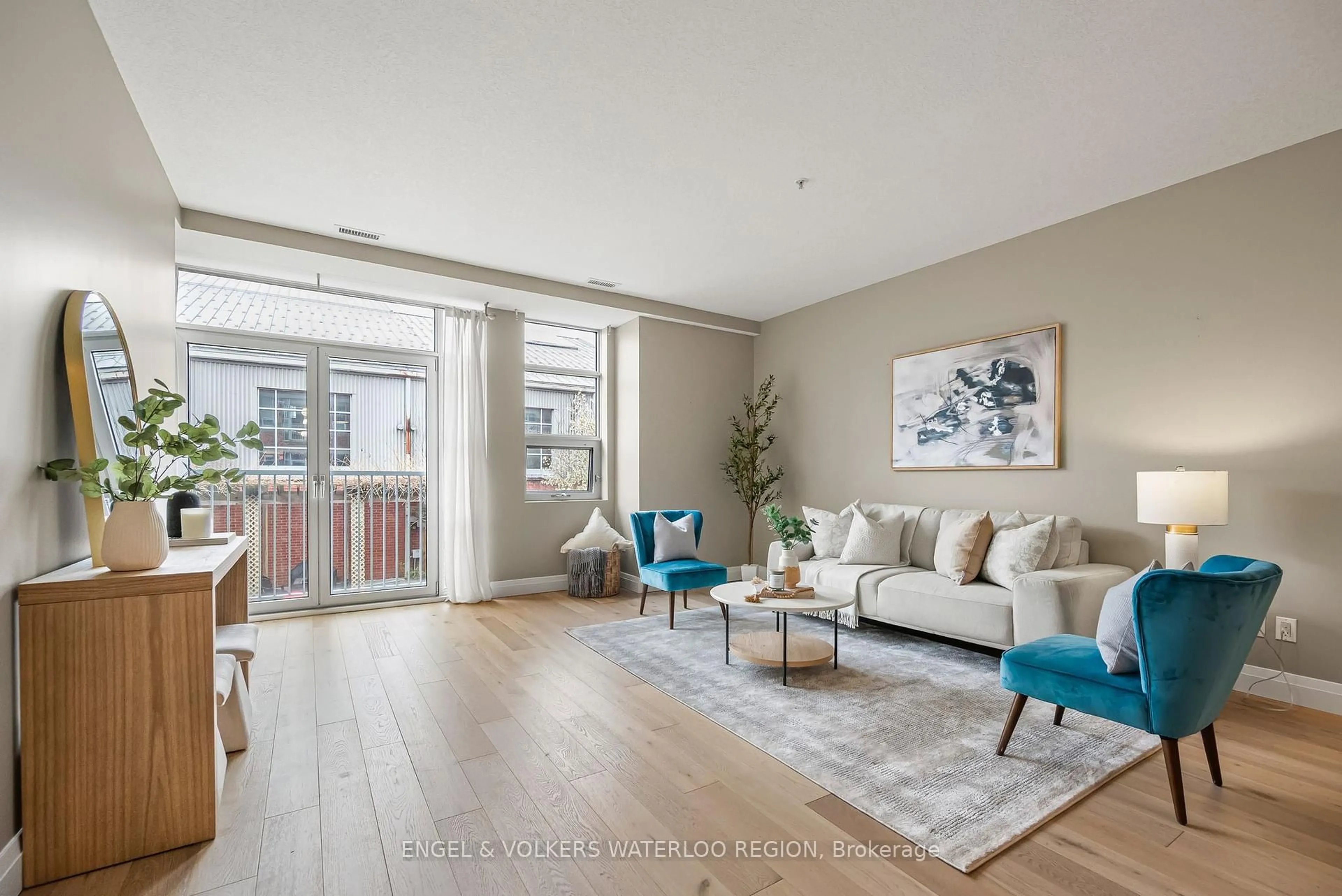 Living room with furniture, wood/laminate floor for 165 Duke St #212, Kitchener Ontario N2H 6M4