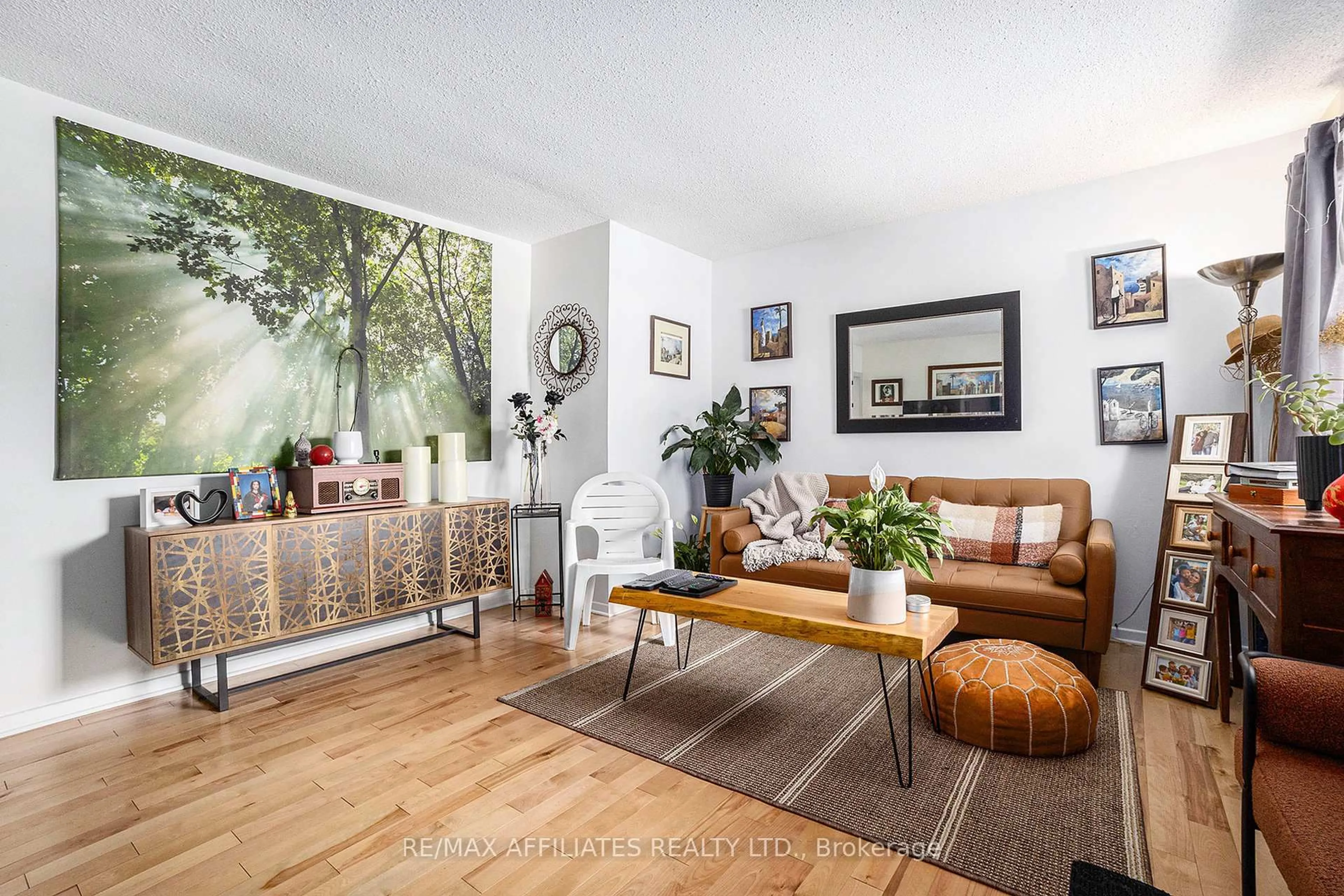 Living room with furniture, wood/laminate floor for 6208 Renaud Rd, Orleans Ontario K1W 0L1
