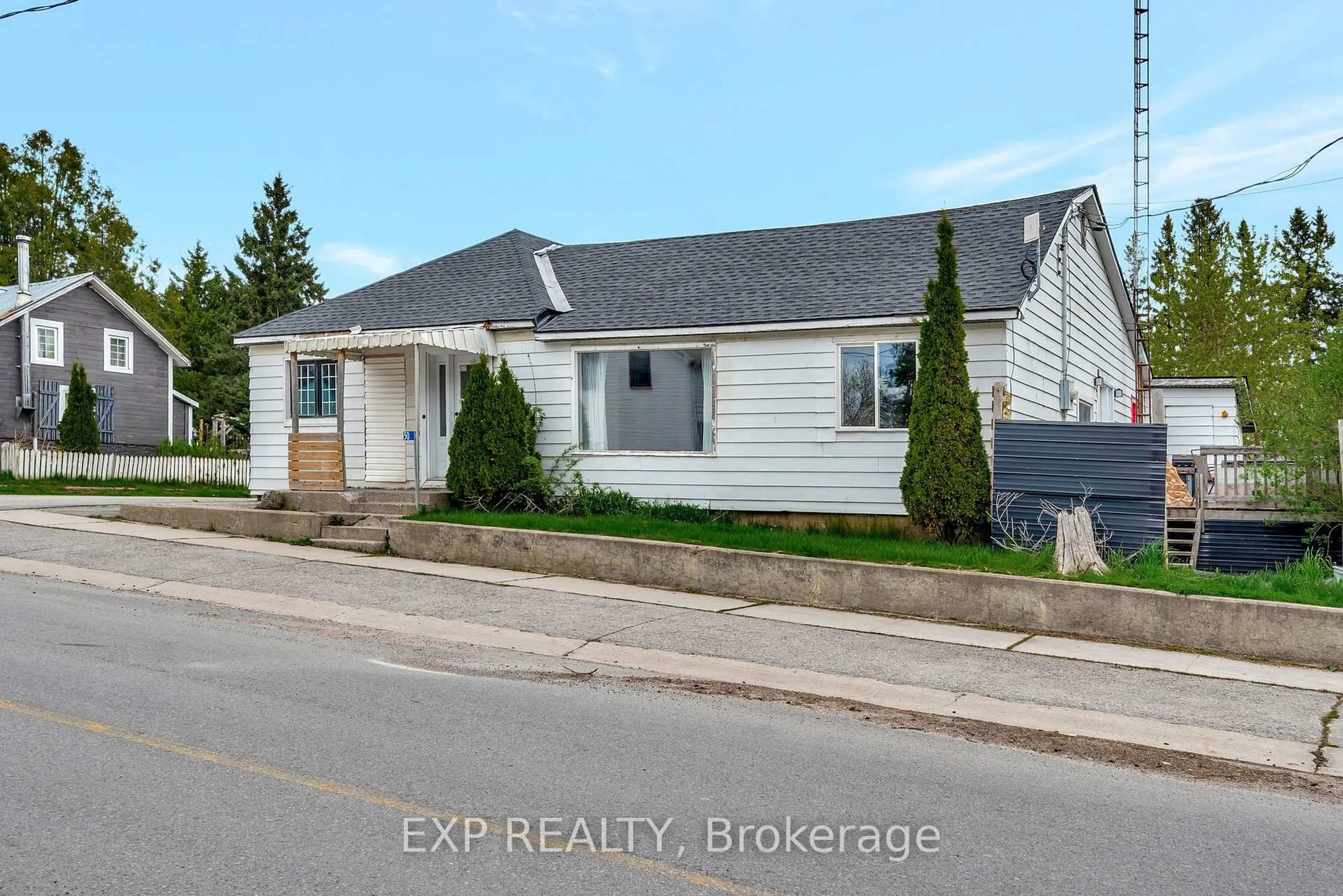 Home with vinyl exterior material, street for 50 Queen St, Tweed Ontario K0K 2L0