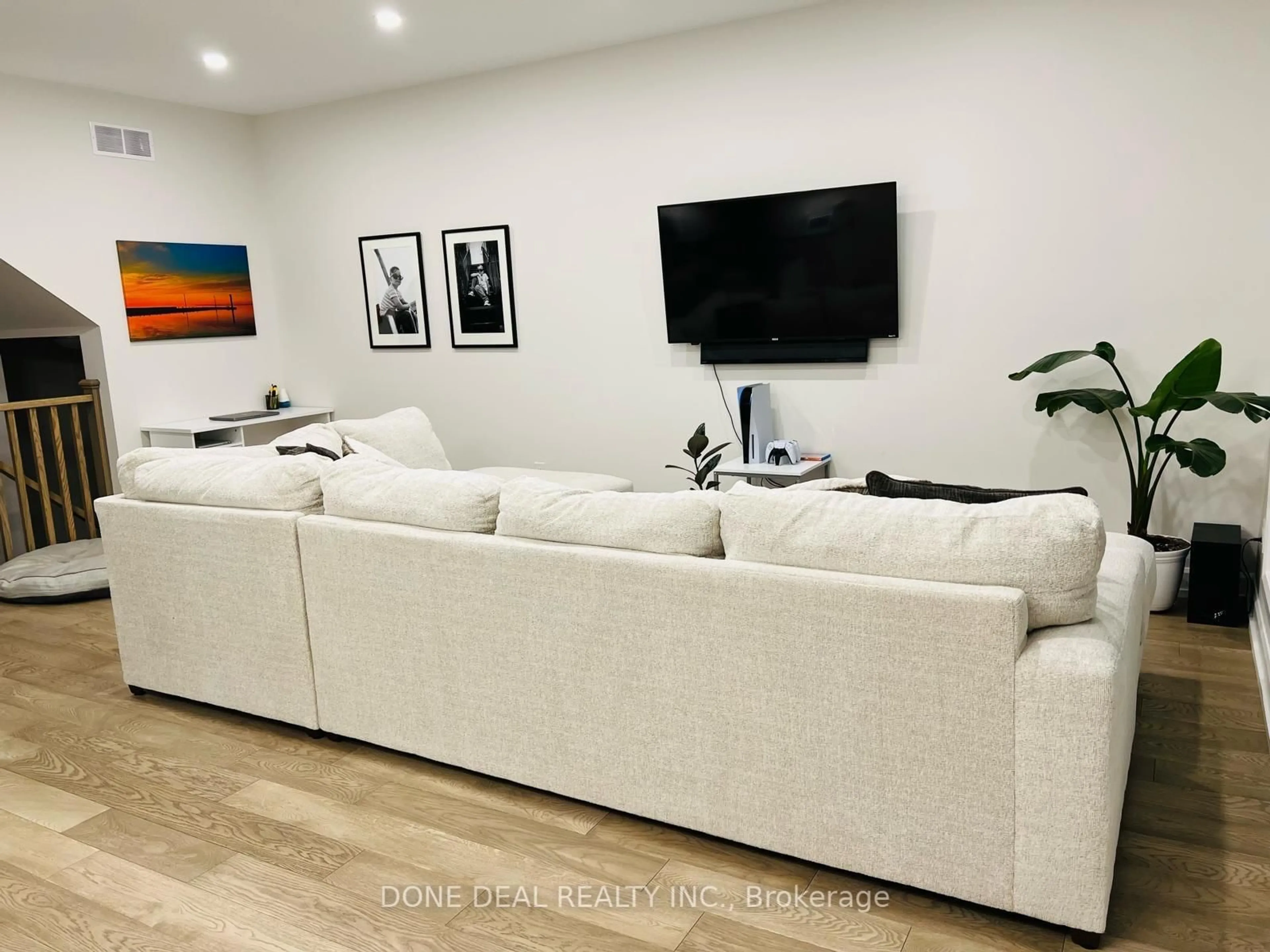 Living room with furniture, wood/laminate floor for 7166 Parsa St, Niagara Falls Ontario L2H 3T2