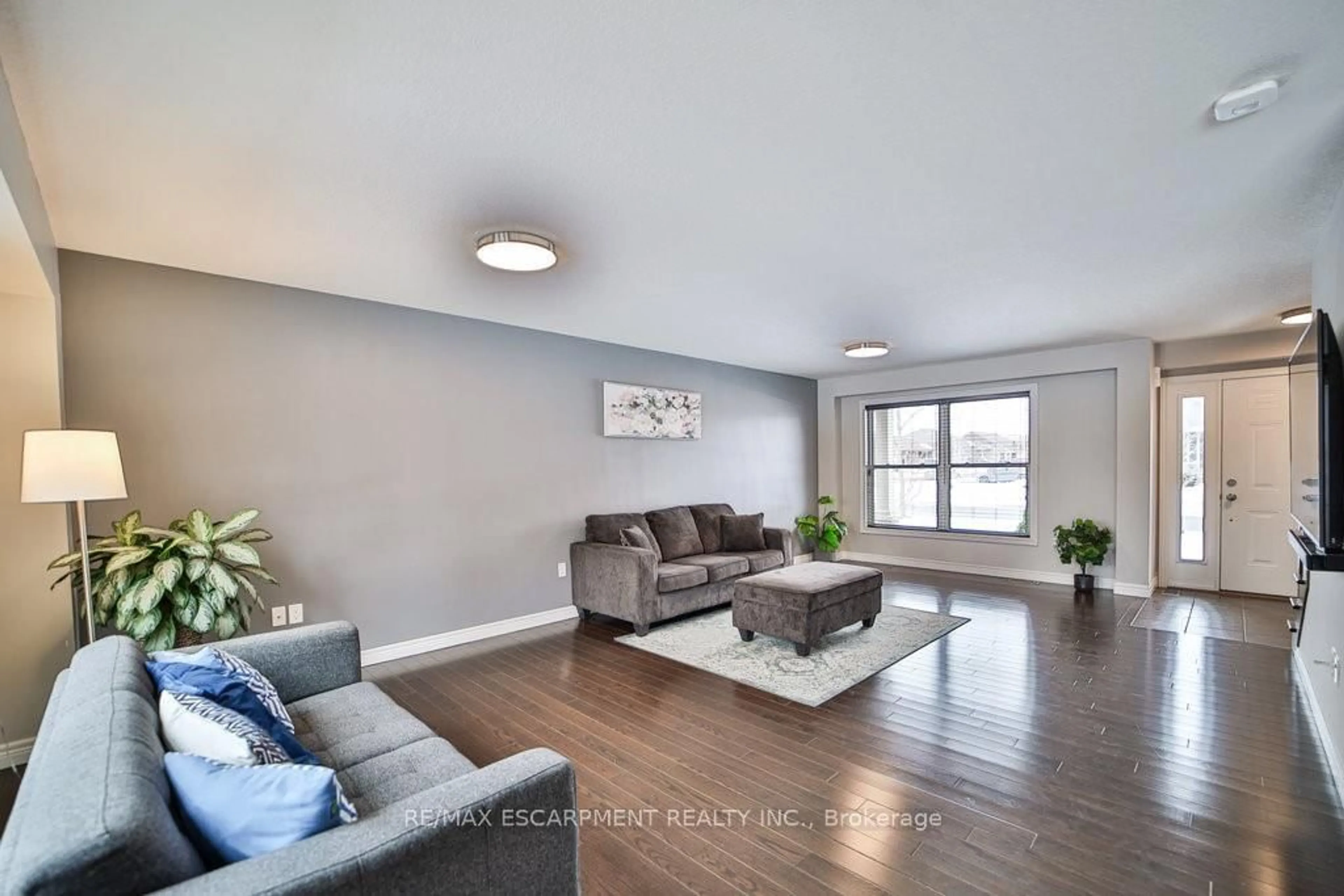 Living room with furniture, wood/laminate floor for 54 Harvest Gate, West Lincoln Ontario L0R 2A0