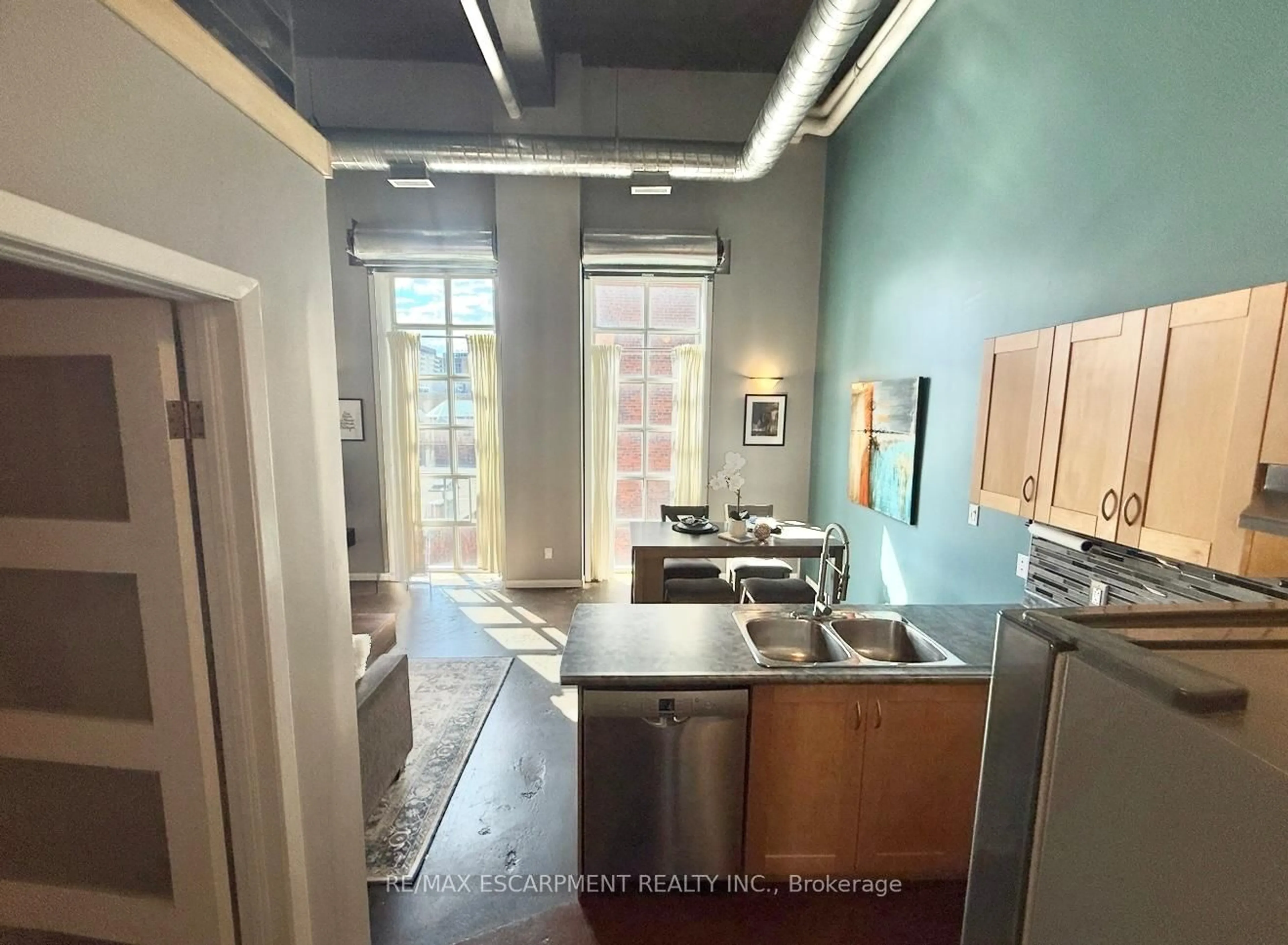 Kitchen with laundary machines, unknown for 11 Rebecca St #406, Hamilton Ontario L8R 3H7