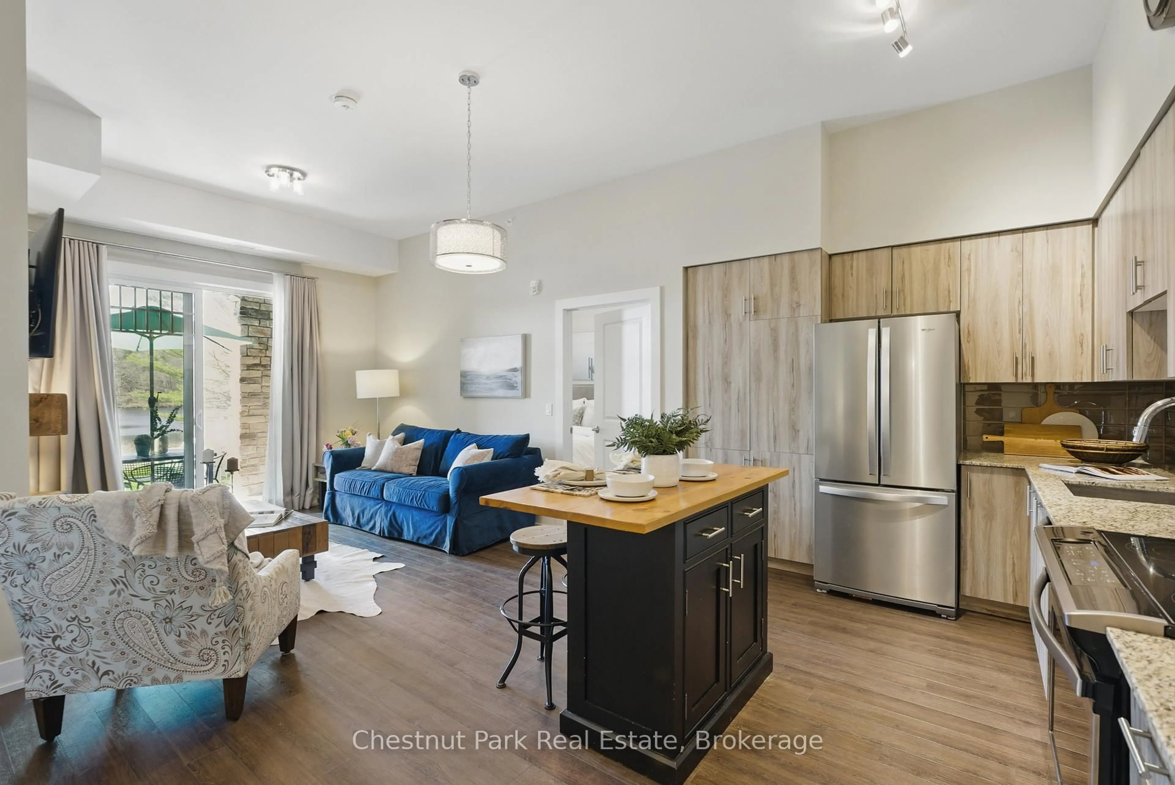 Open concept kitchen, wood/laminate floor for 25 Pen Lake Point Rd #2, Huntsville Ontario P1H 1A9