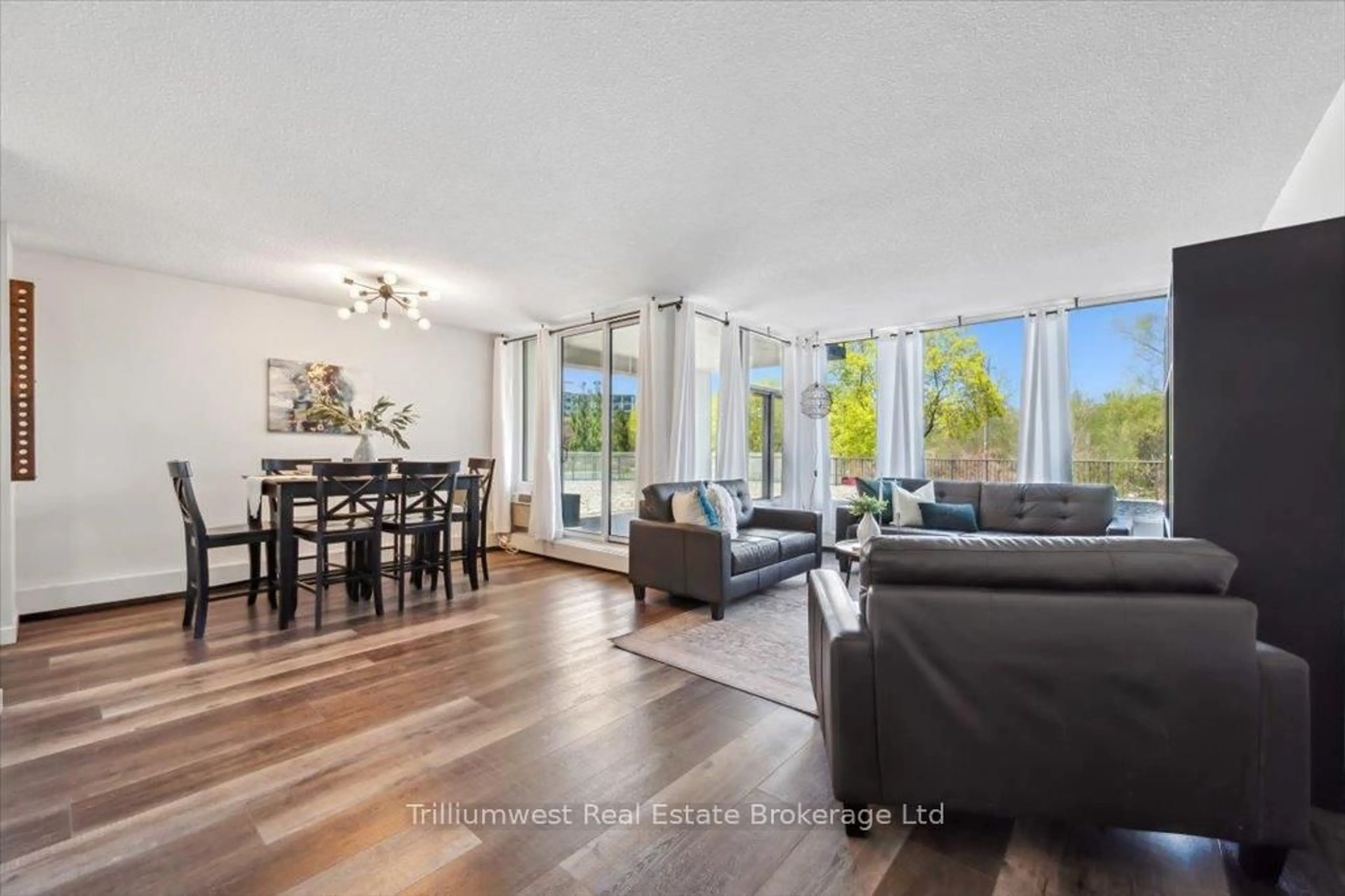Living room with furniture, wood/laminate floor for 23 Woodlawn Rd #103, Guelph Ontario N1H 7G6