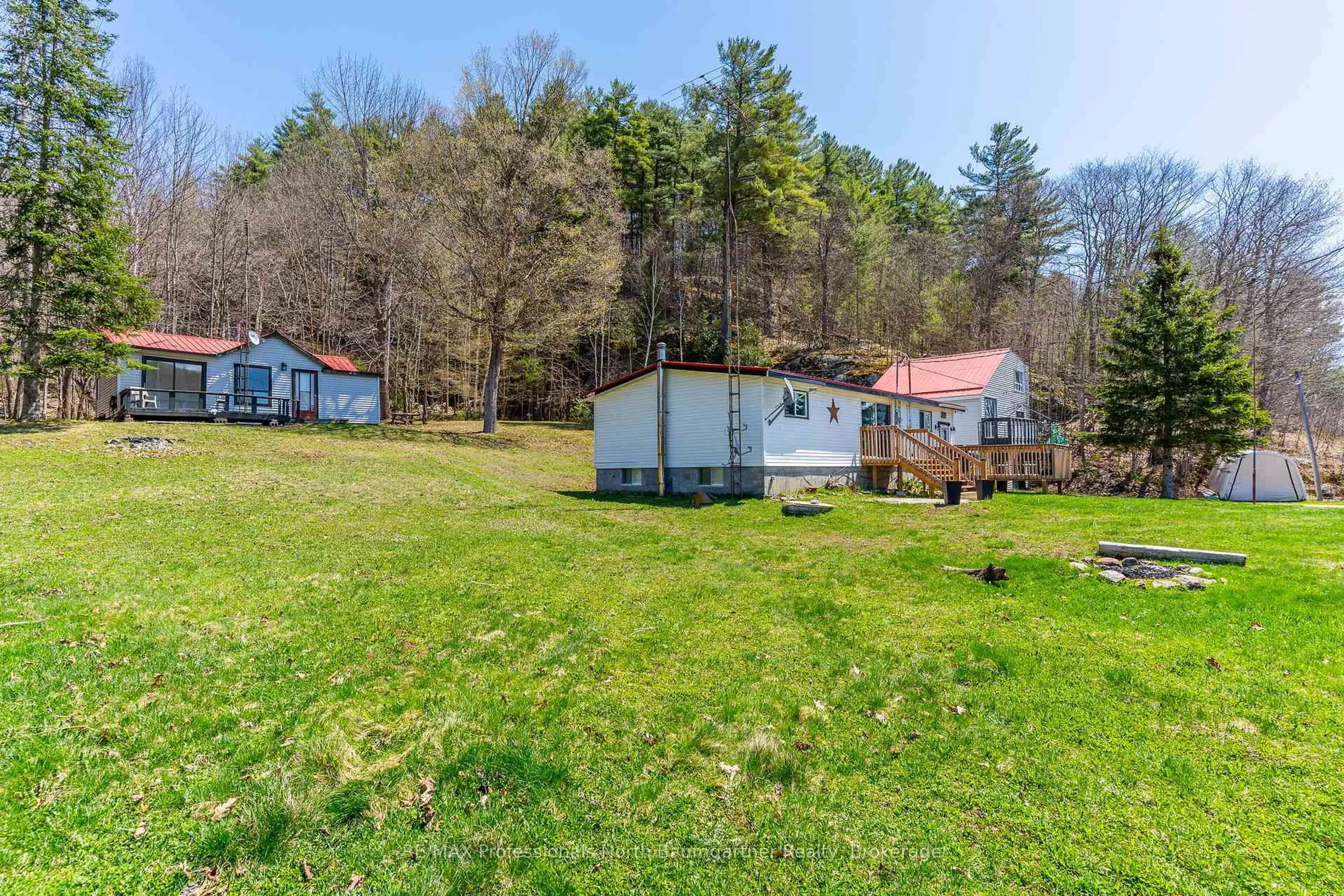 A pic from outside/outdoor area/front of a property/back of a property/a pic from drone, water/lake/river/ocean view for 18830 Hwy 35, Algonquin Highlands Ontario K0M 1J2