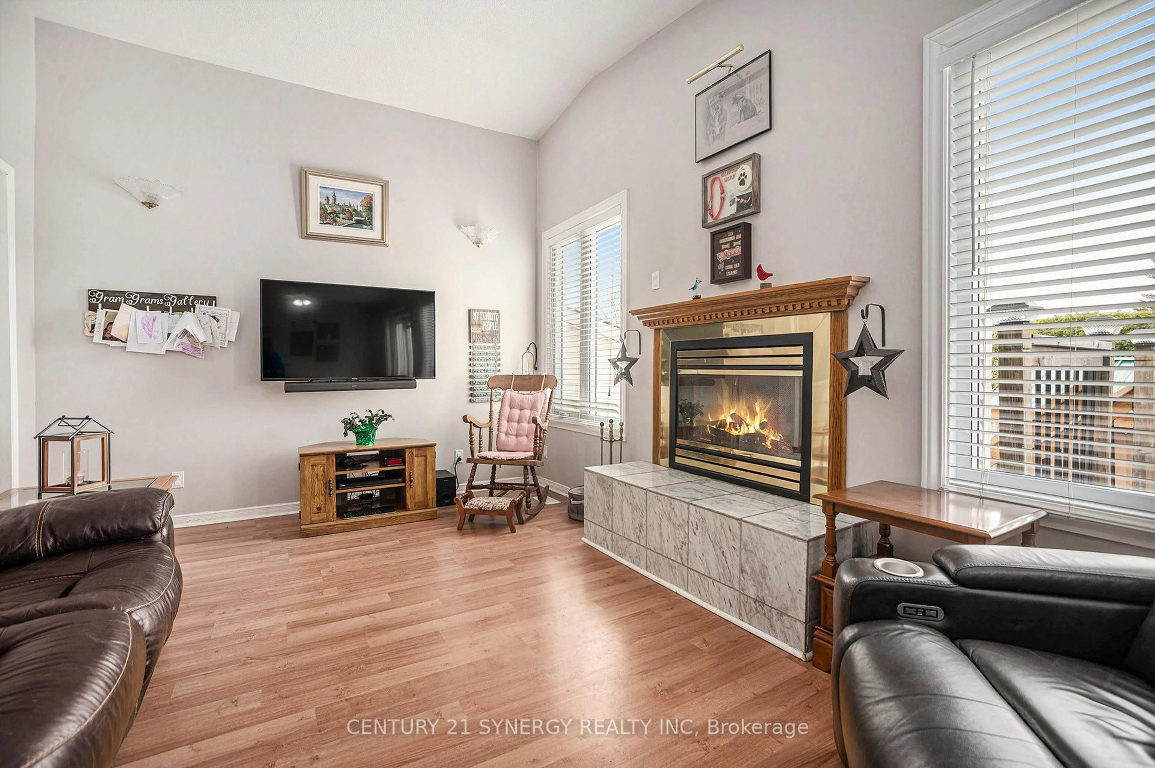 Living room with furniture, wood/laminate floor for 47 Fringewood Dr, Ottawa Ontario K2S 1T8
