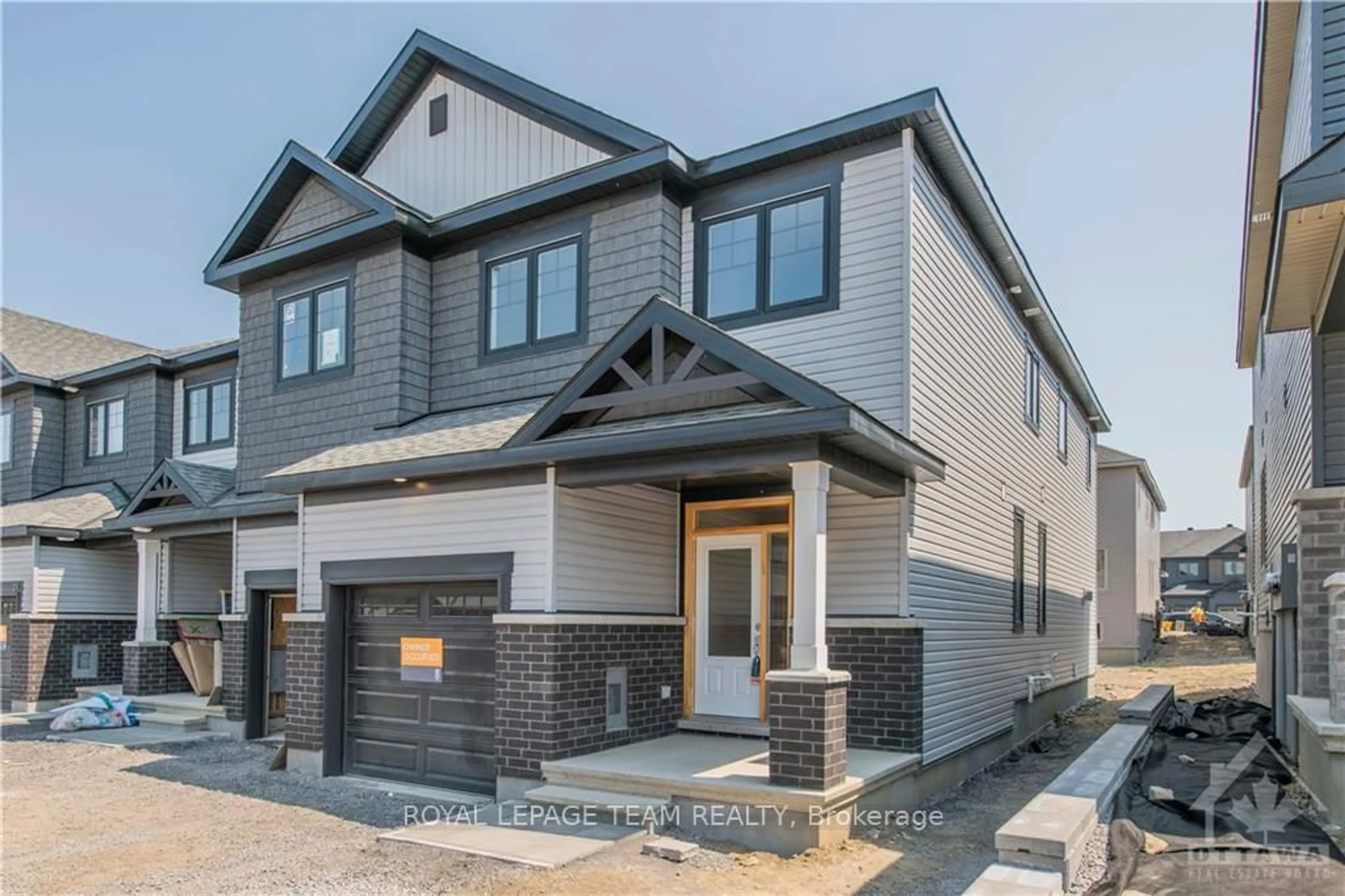 Home with brick exterior material, street for 25 Atop Lane, Ottawa Ontario K1X 1G6