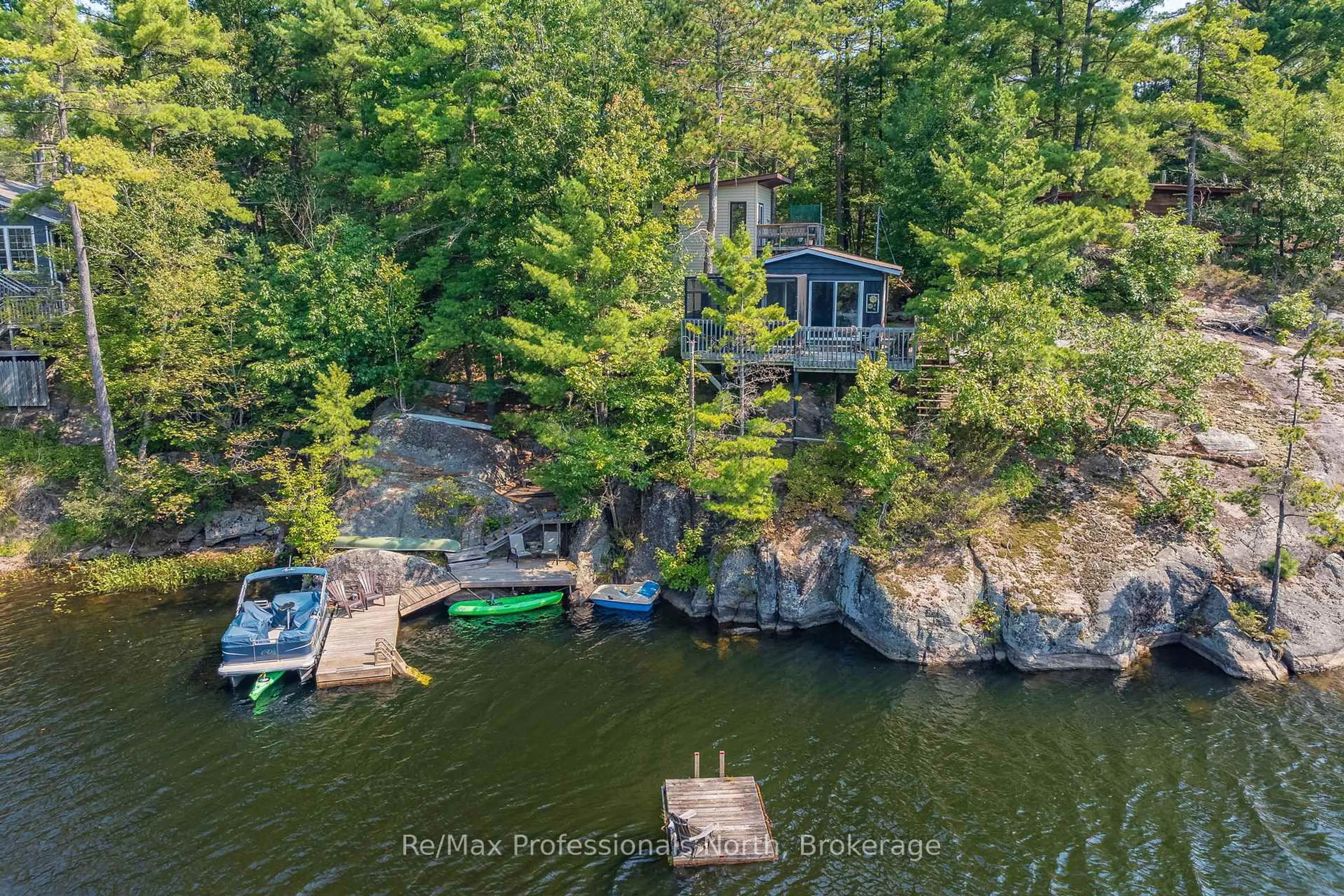 A pic from outside/outdoor area/front of a property/back of a property/a pic from drone, water/lake/river/ocean view for 1118 Tomingas Rd, Gravenhurst Ontario P1P 0G3