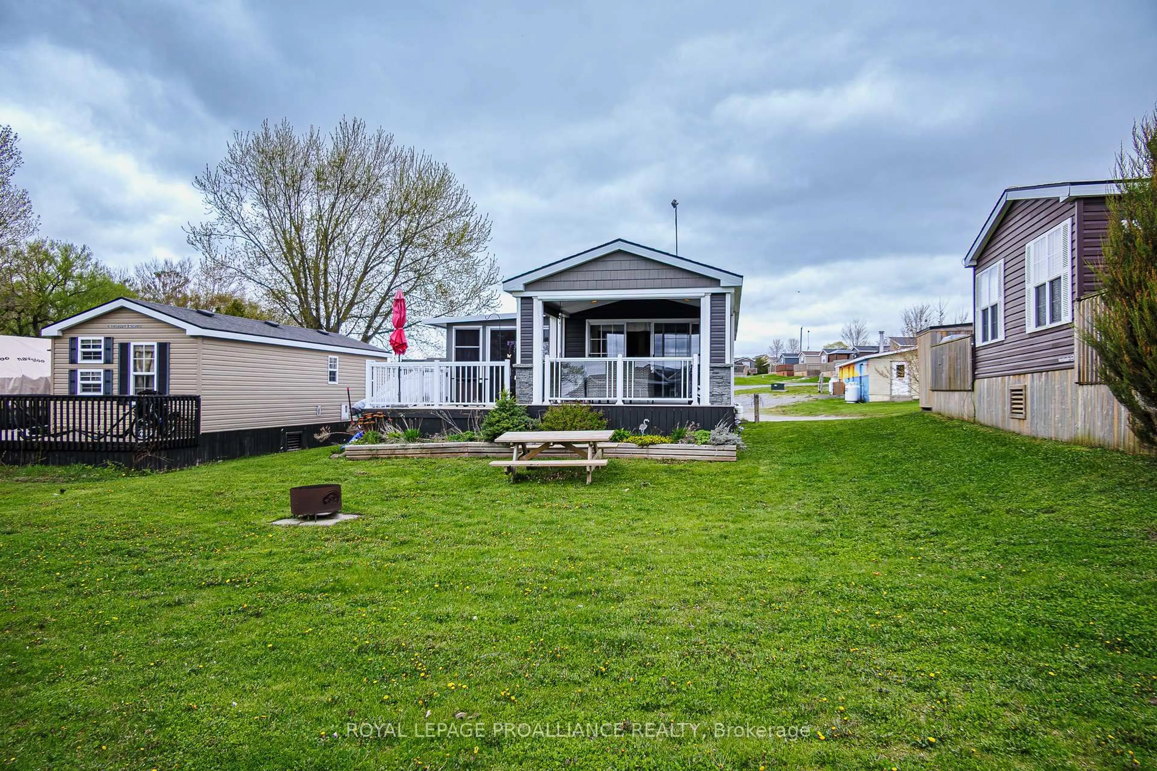 A pic from outside/outdoor area/front of a property/back of a property/a pic from drone, water/lake/river/ocean view for 486 County Road 18 #3 Cherry Beach Lane, Prince Edward County Ontario K0K 1P0