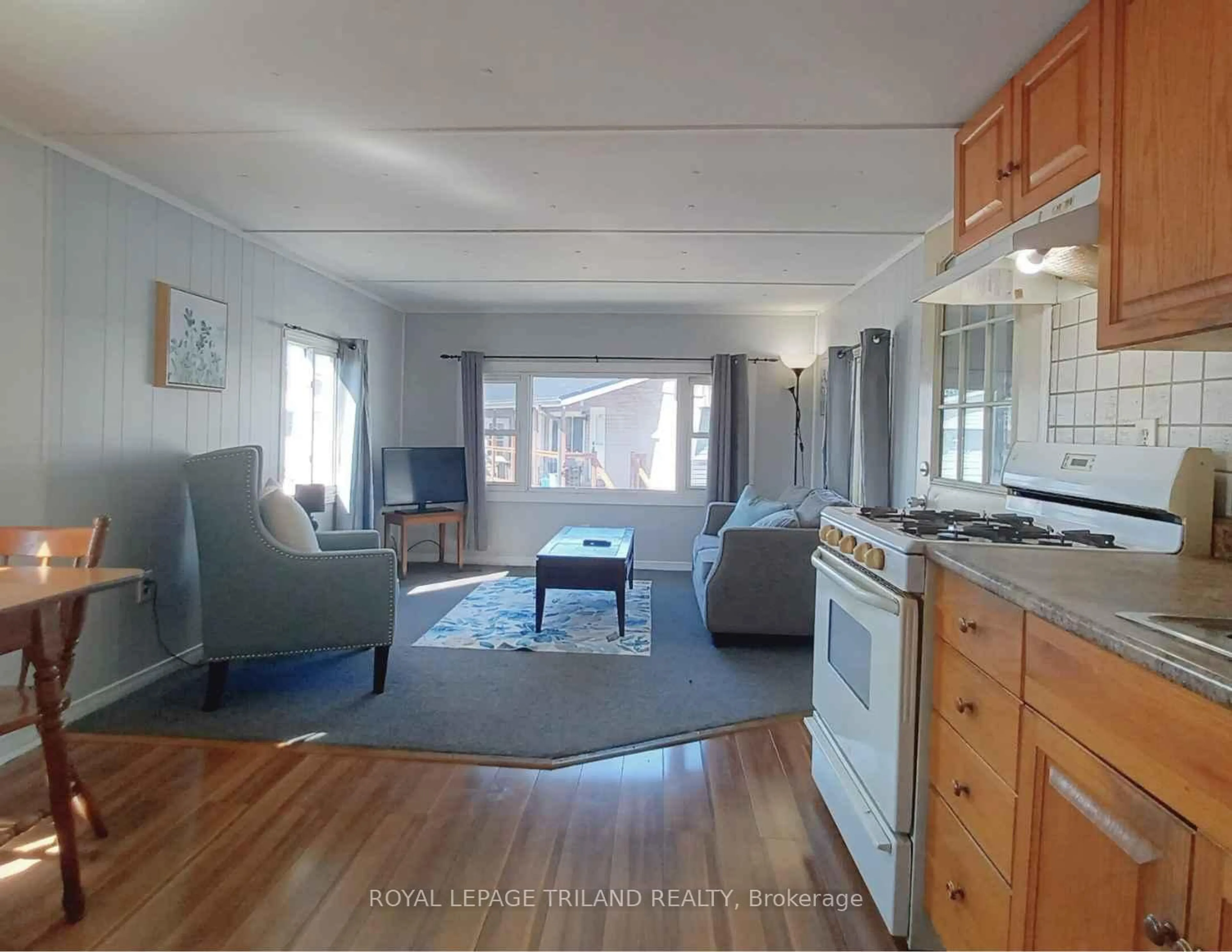 Living room with furniture, wood/laminate floor for 2189 Dundas St #54, London East Ontario N5V 1H3