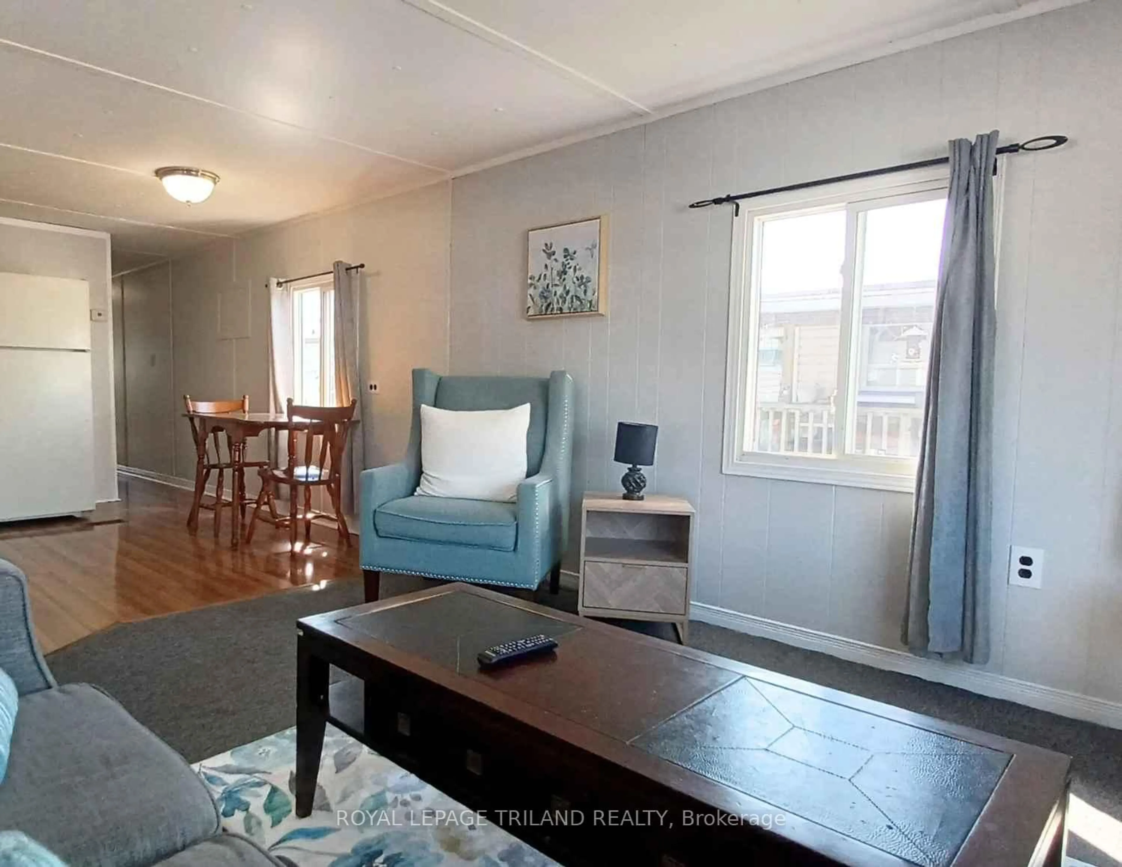 Living room with furniture, wood/laminate floor for 2189 Dundas St #54, London East Ontario N5V 1H3