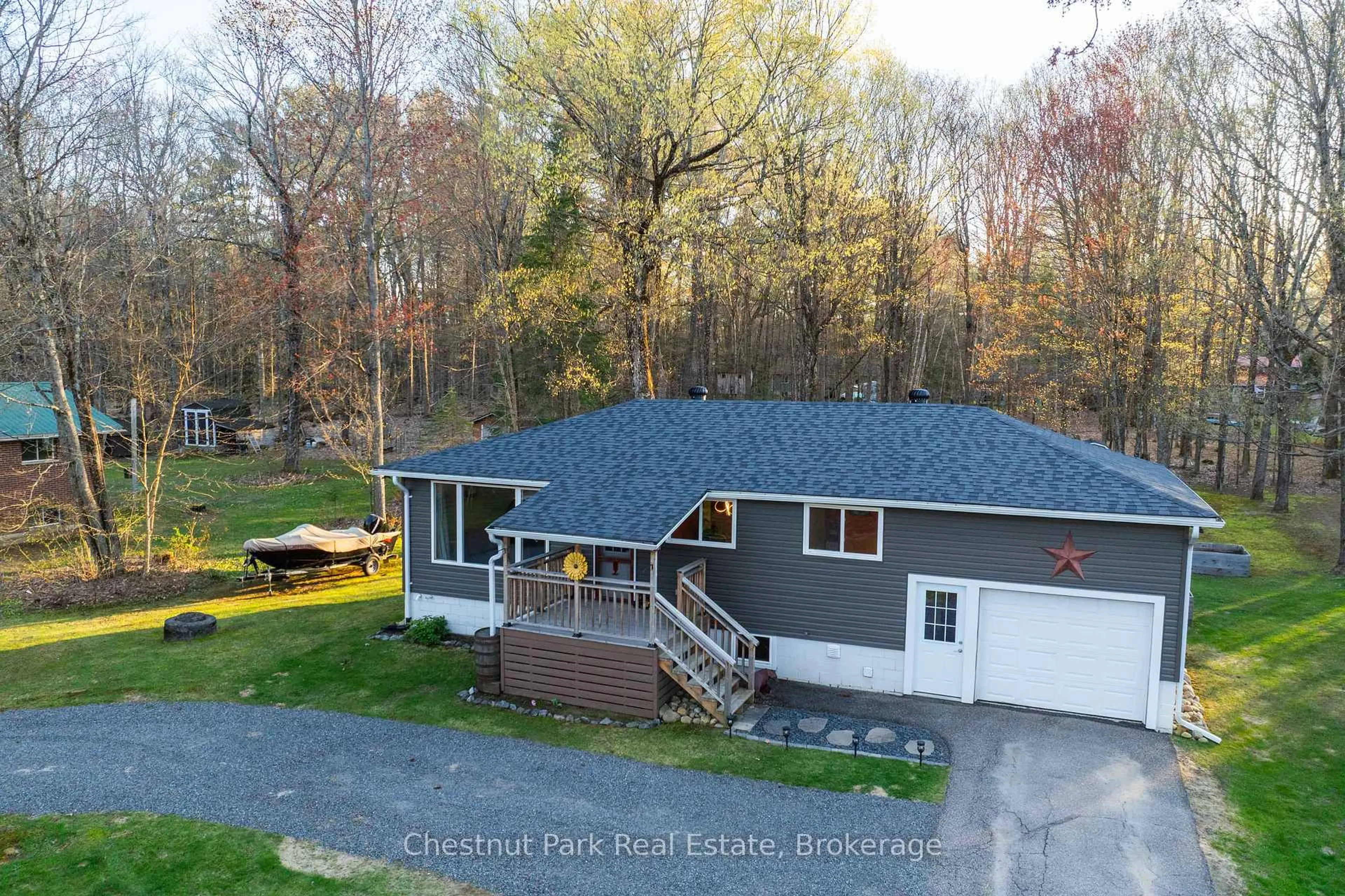 A pic from outside/outdoor area/front of a property/back of a property/a pic from drone, water/lake/river/ocean view for 104 Bridgedale Rd, Huntsville Ontario P0B 1L0