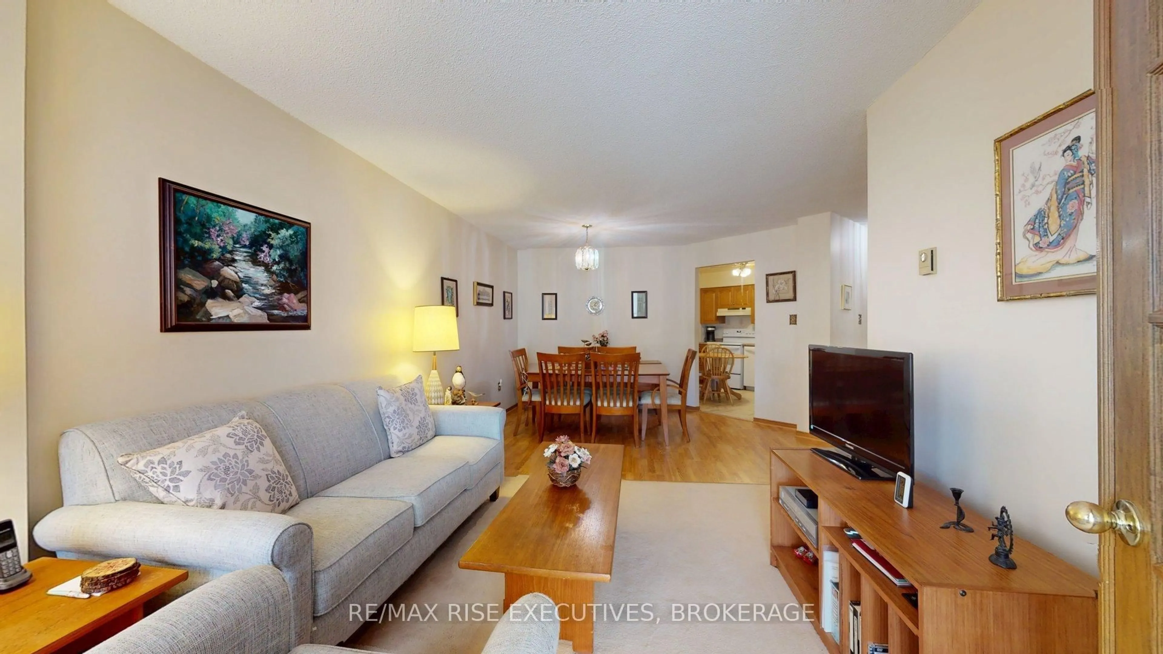 Living room with furniture, wood/laminate floor for 675 Davis Dr #410, Kingston Ontario K7M 8L5