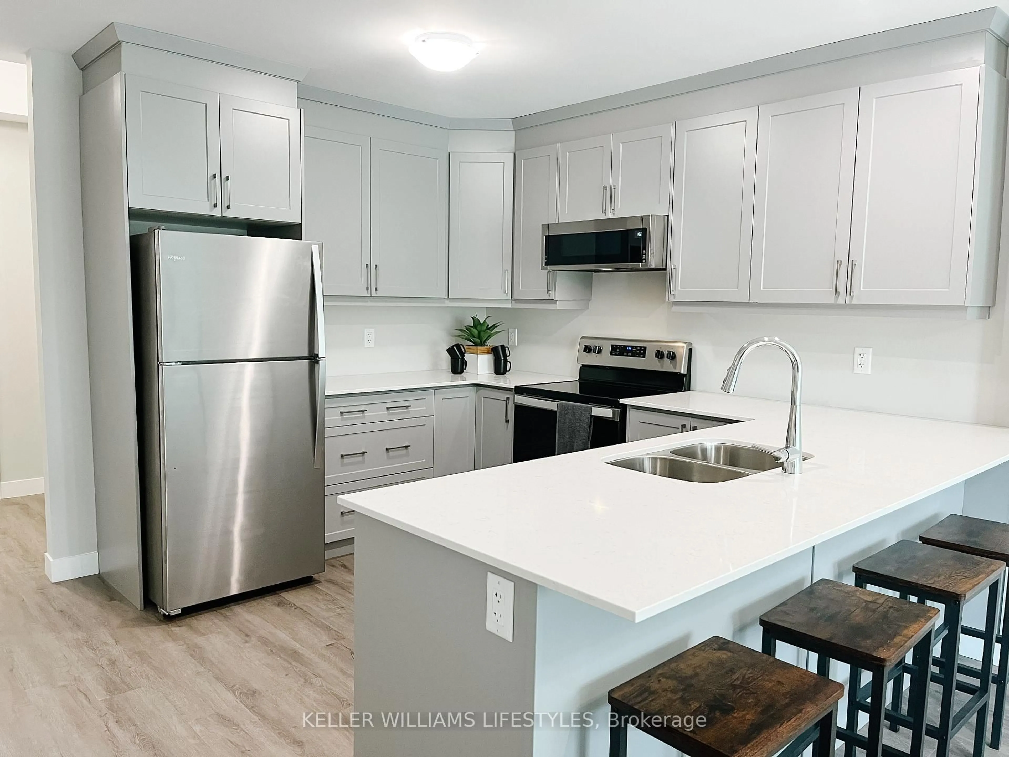 Open concept kitchen, wood/laminate floor for 100 The Promenade Rd #104, Central Elgin Ontario N5L 0B7