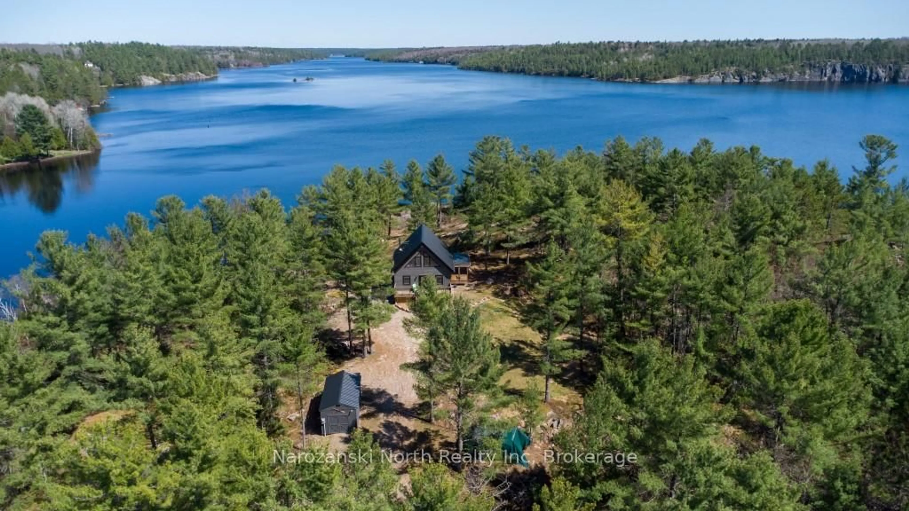 A pic from outside/outdoor area/front of a property/back of a property/a pic from drone, water/lake/river/ocean view for 118 B Plouffe Rd, French River Ontario P0M 2N0
