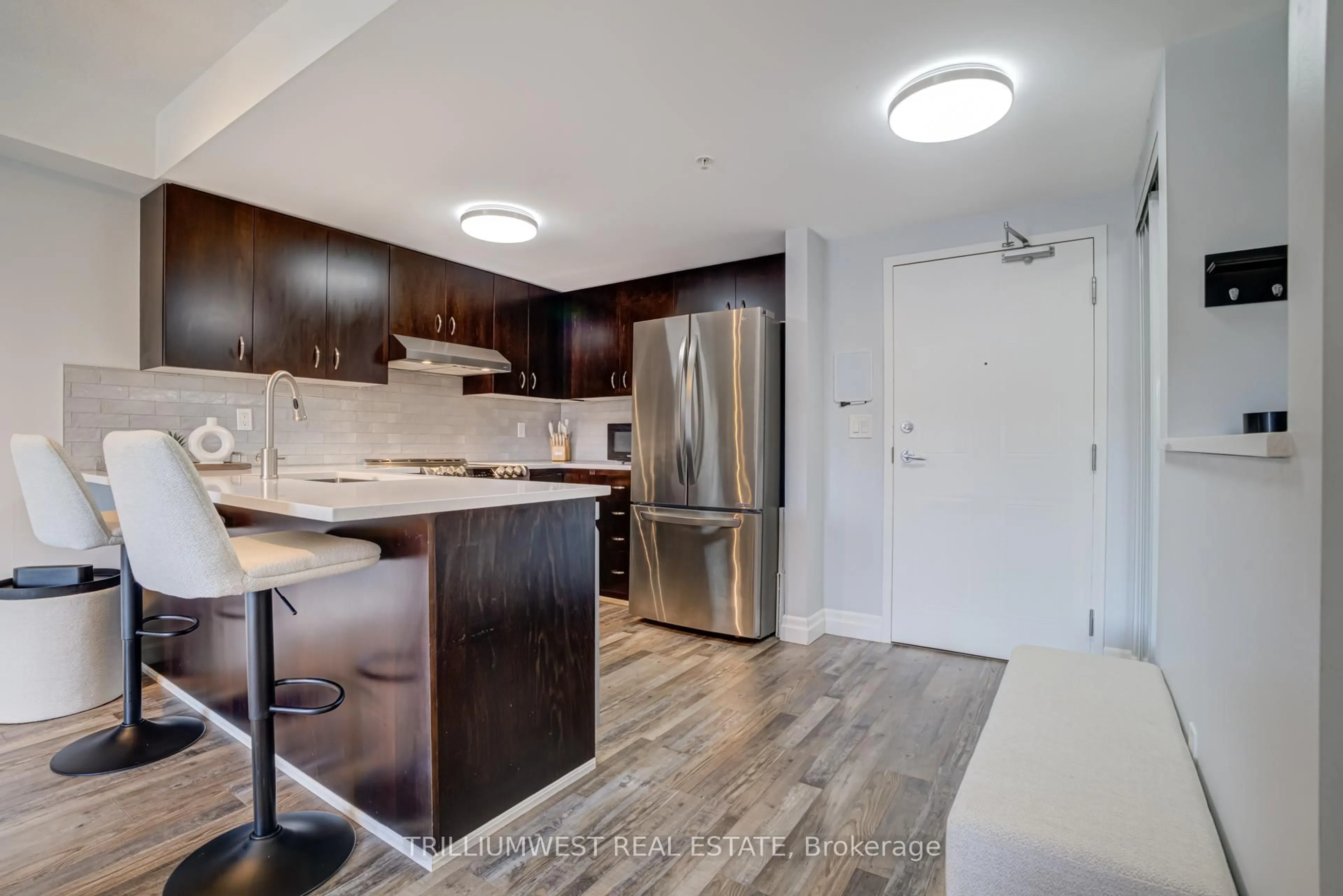 Open concept kitchen, wood/laminate floor for 43 Goodwin Dr #201, Guelph Ontario N1L 0E8