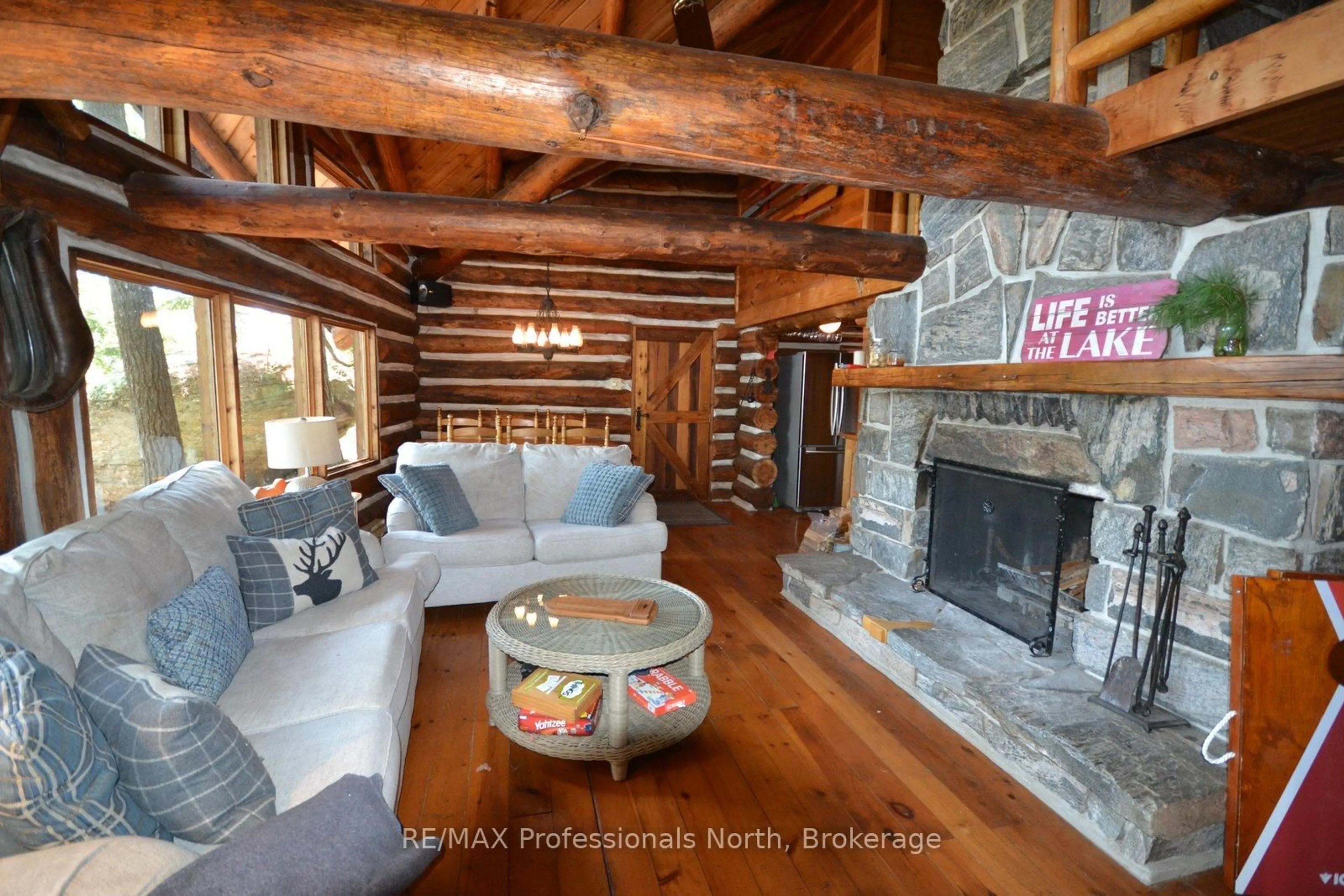 Living room with furniture, wood/laminate floor for 11008 Hunter Island, Dysart et al Ontario K0M 1S0
