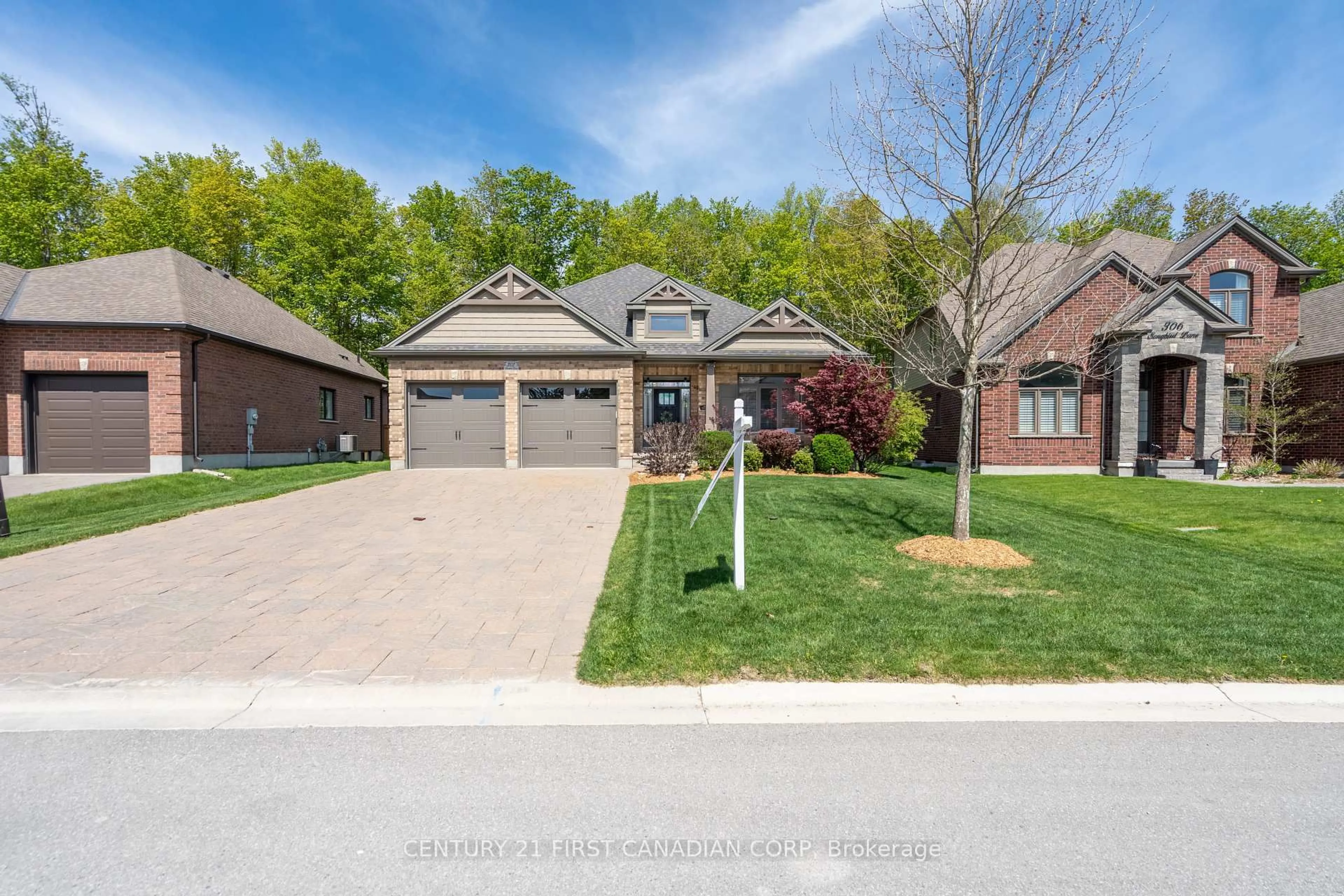 Home with brick exterior material, street for 302 Songbird Lane, Middlesex Centre Ontario N0M 2A0