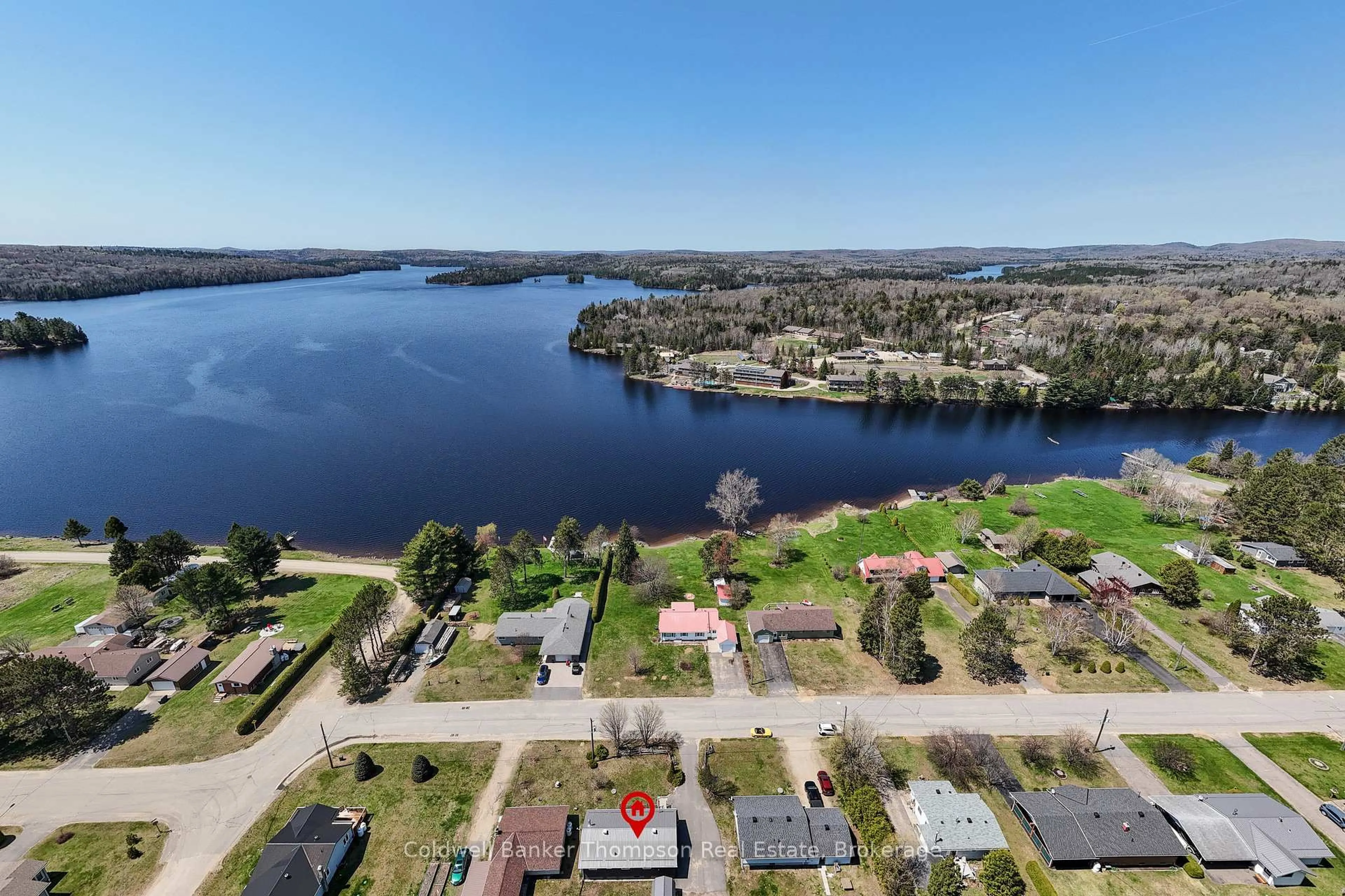 A pic from outside/outdoor area/front of a property/back of a property/a pic from drone, water/lake/river/ocean view for 45 Lake St, South Algonquin Ontario K0J 2M0