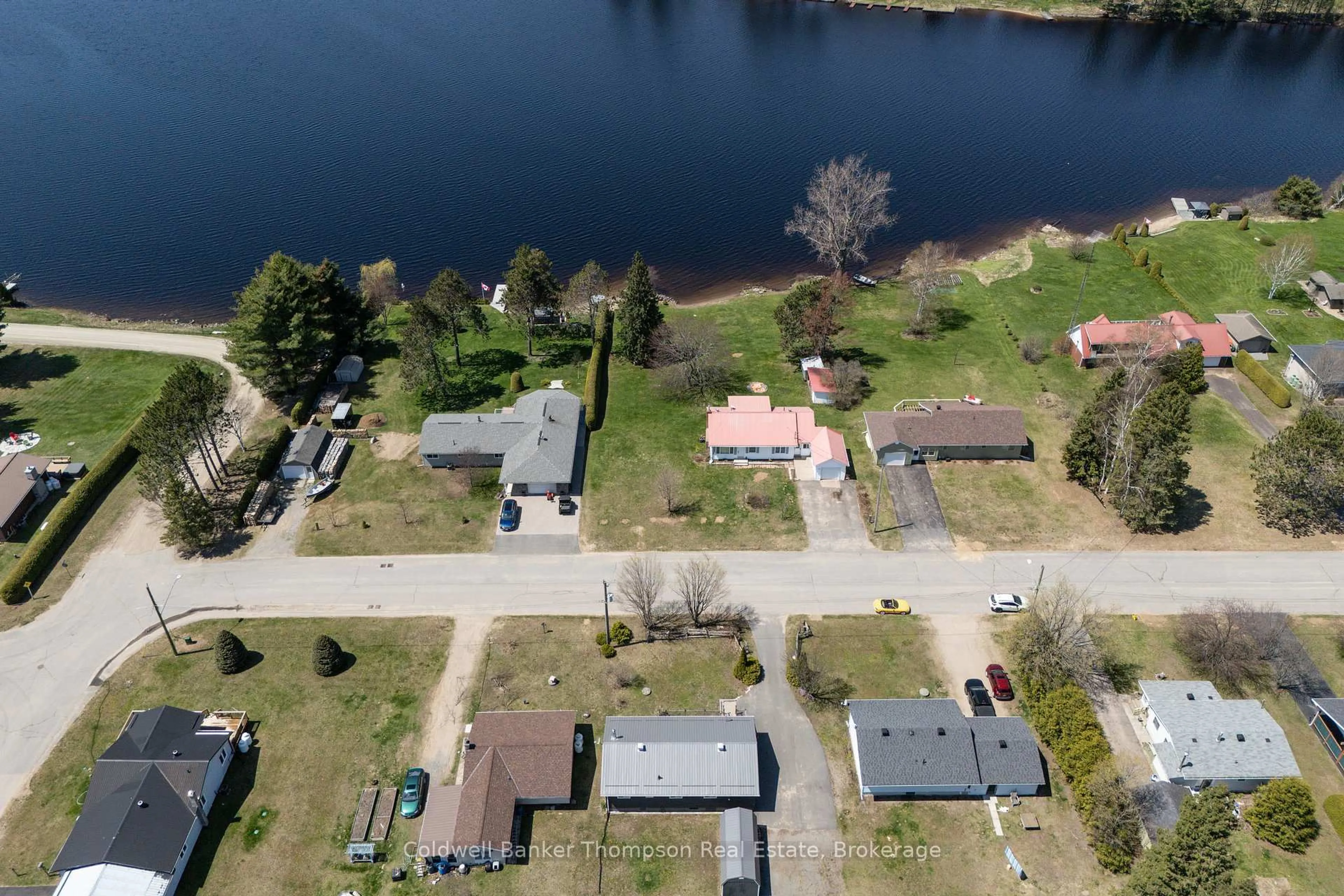A pic from outside/outdoor area/front of a property/back of a property/a pic from drone, water/lake/river/ocean view for 45 Lake St, South Algonquin Ontario K0J 2M0