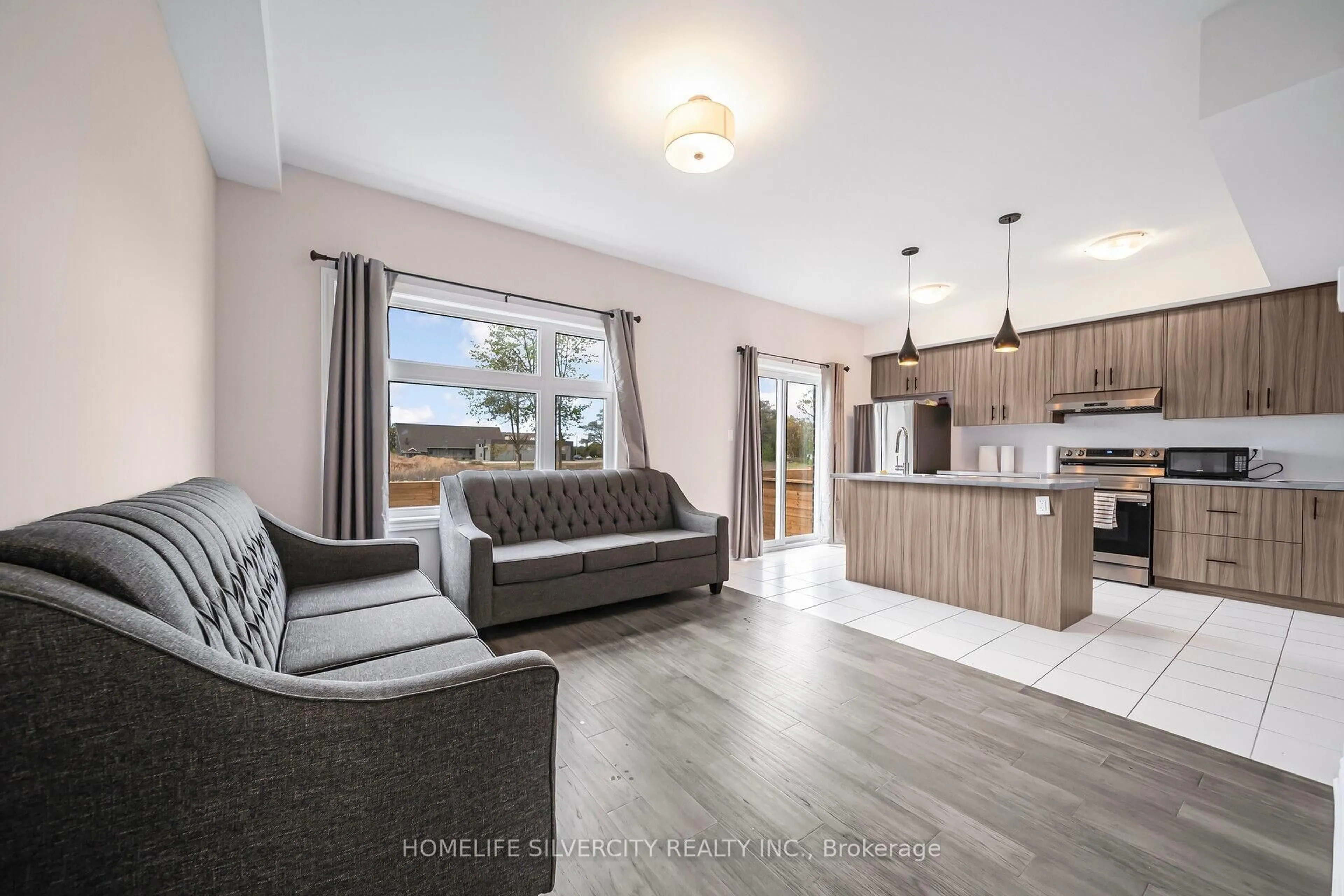 Open concept kitchen, wood/laminate floor for 5672 Dorchester Rd #4, Niagara Falls Ontario L2G 4Y8