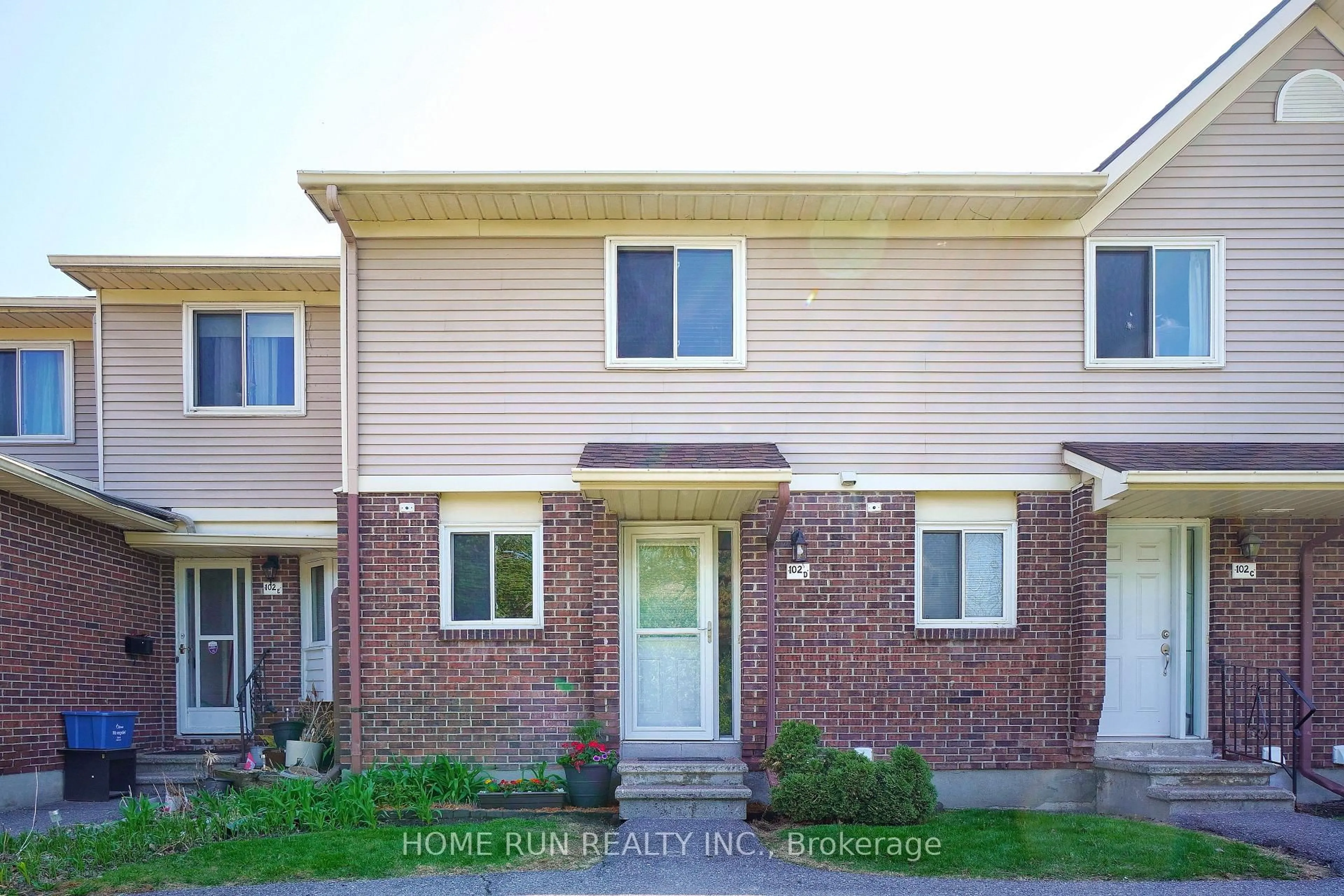 Home with brick exterior material, street for 102 Valley Stream Dr #D, Ottawa Ontario K2H 9E1