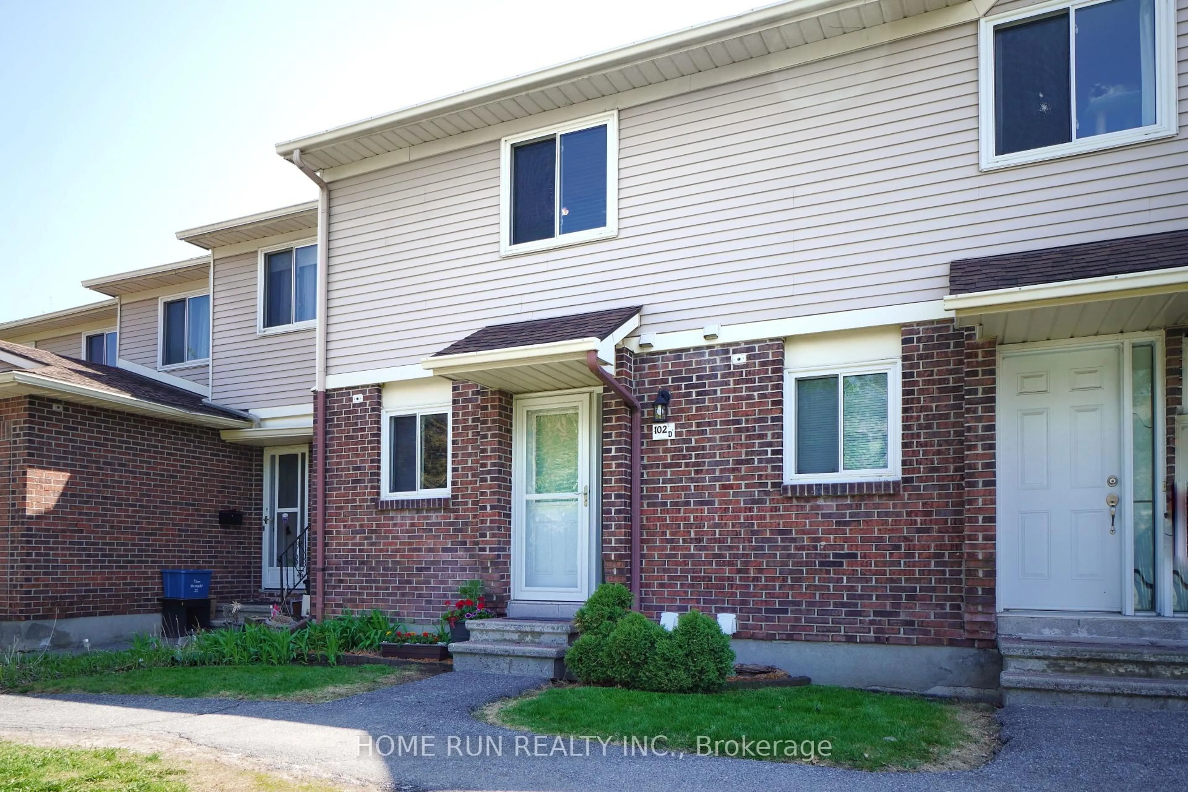 Home with brick exterior material, street for 102 Valley Stream Dr #D, Ottawa Ontario K2H 9E1