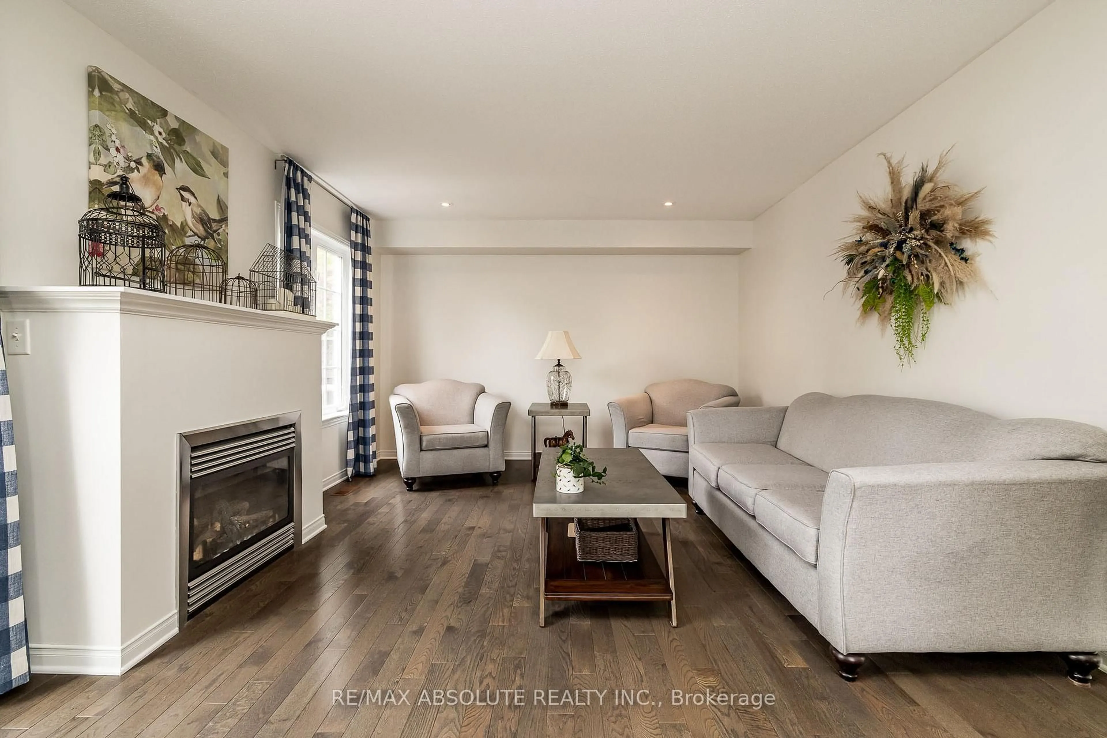 Living room with furniture, wood/laminate floor for 400 Evenwood Pvt N/A, Ottawa Ontario K2J 0E5