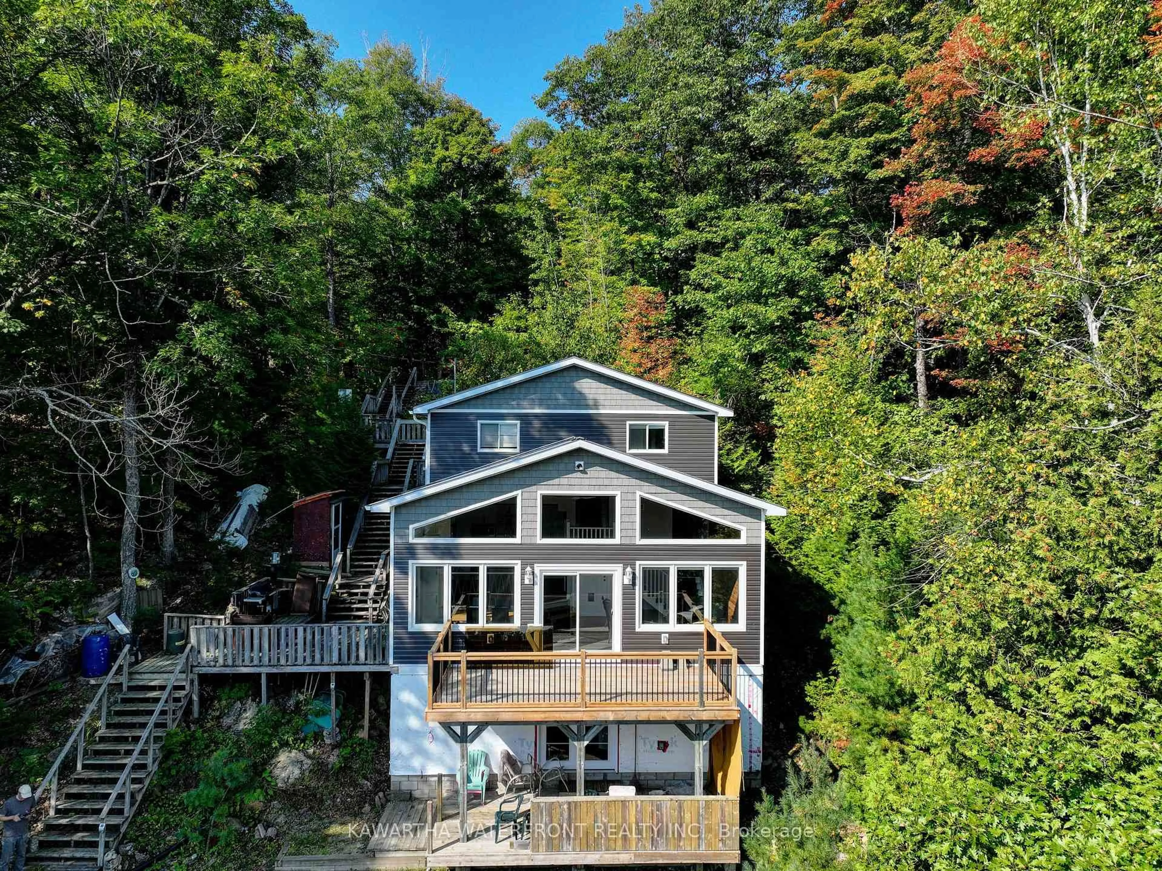 A pic from outside/outdoor area/front of a property/back of a property/a pic from drone, water/lake/river/ocean view for 99 Fire Route 394 Rte, Trent Lakes Ontario K0M 2A0