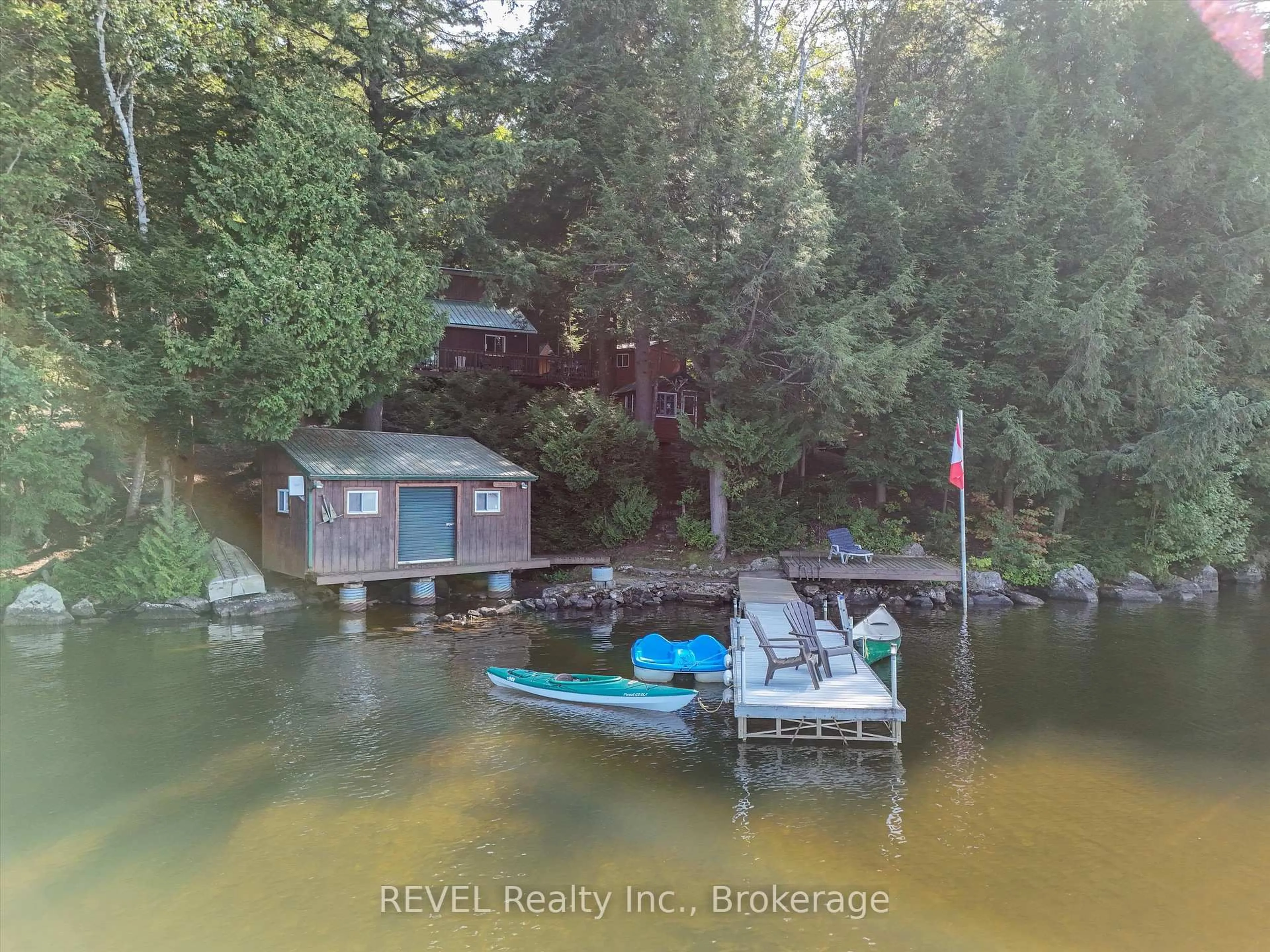 A pic from outside/outdoor area/front of a property/back of a property/a pic from drone, water/lake/river/ocean view for 1077 Rignalls Rd, Bracebridge Ontario P1L 1X1