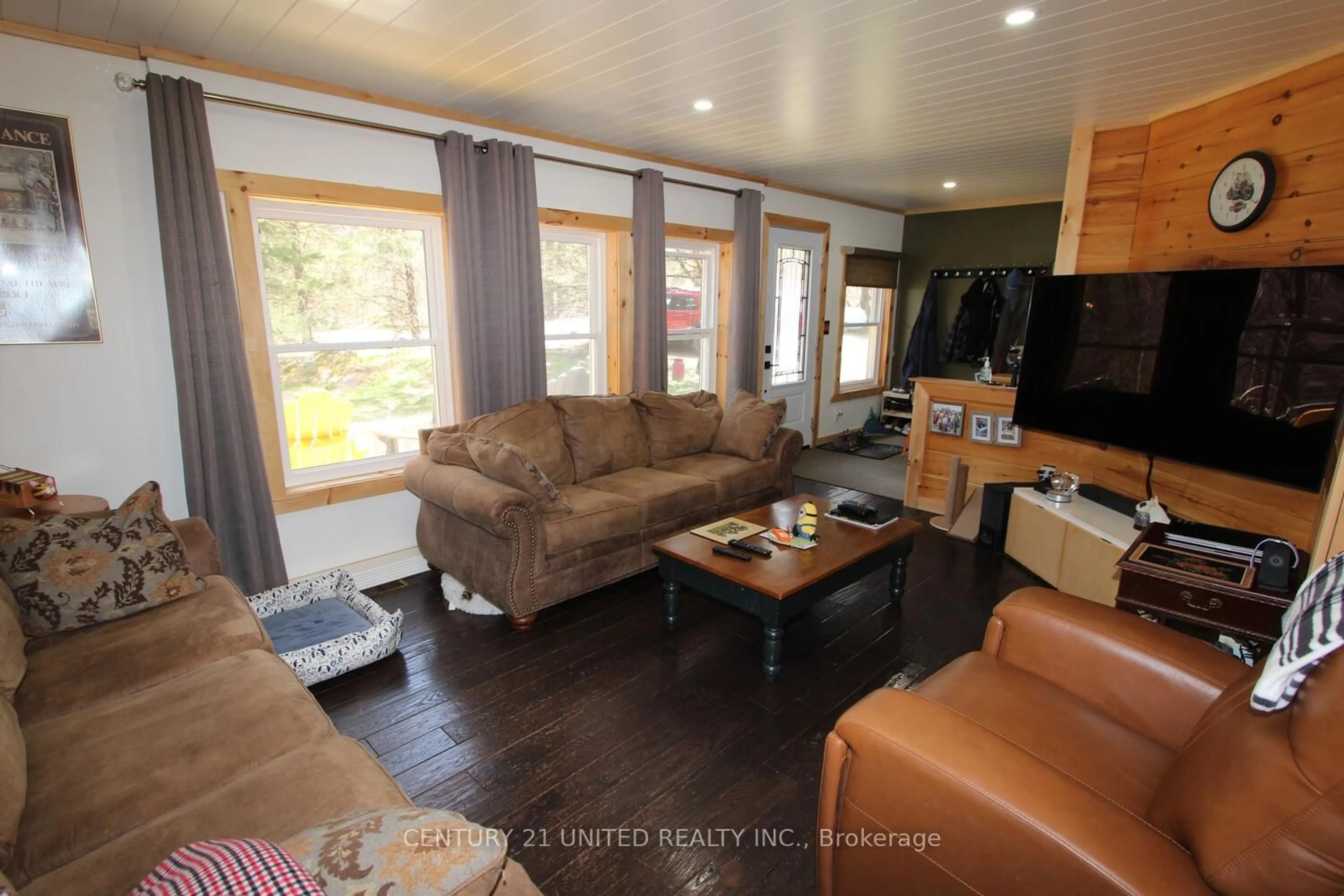 Living room with furniture, wood/laminate floor for 1001 English Circ, Highlands East Ontario K0M 1R0