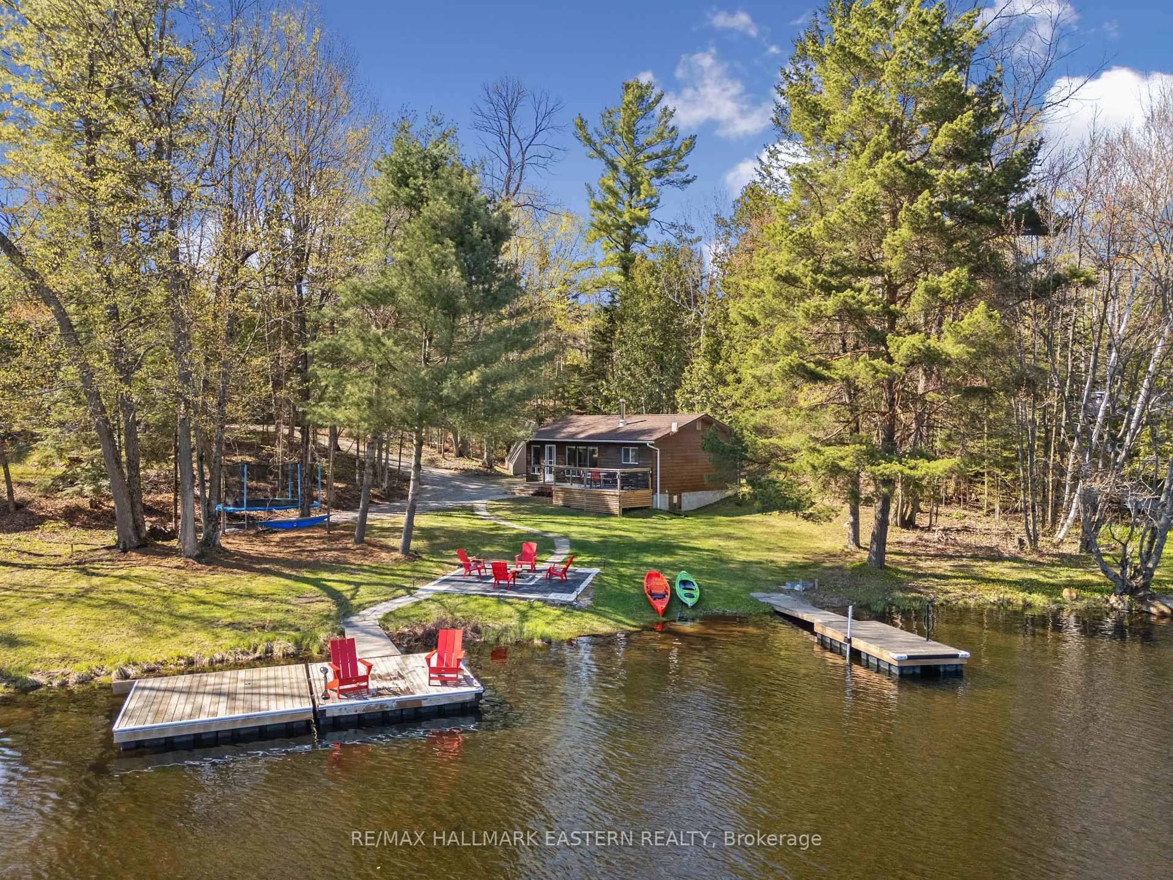 A pic from outside/outdoor area/front of a property/back of a property/a pic from drone, water/lake/river/ocean view for 1025 Dickies Lane, Highlands East Ontario K0M 1R0