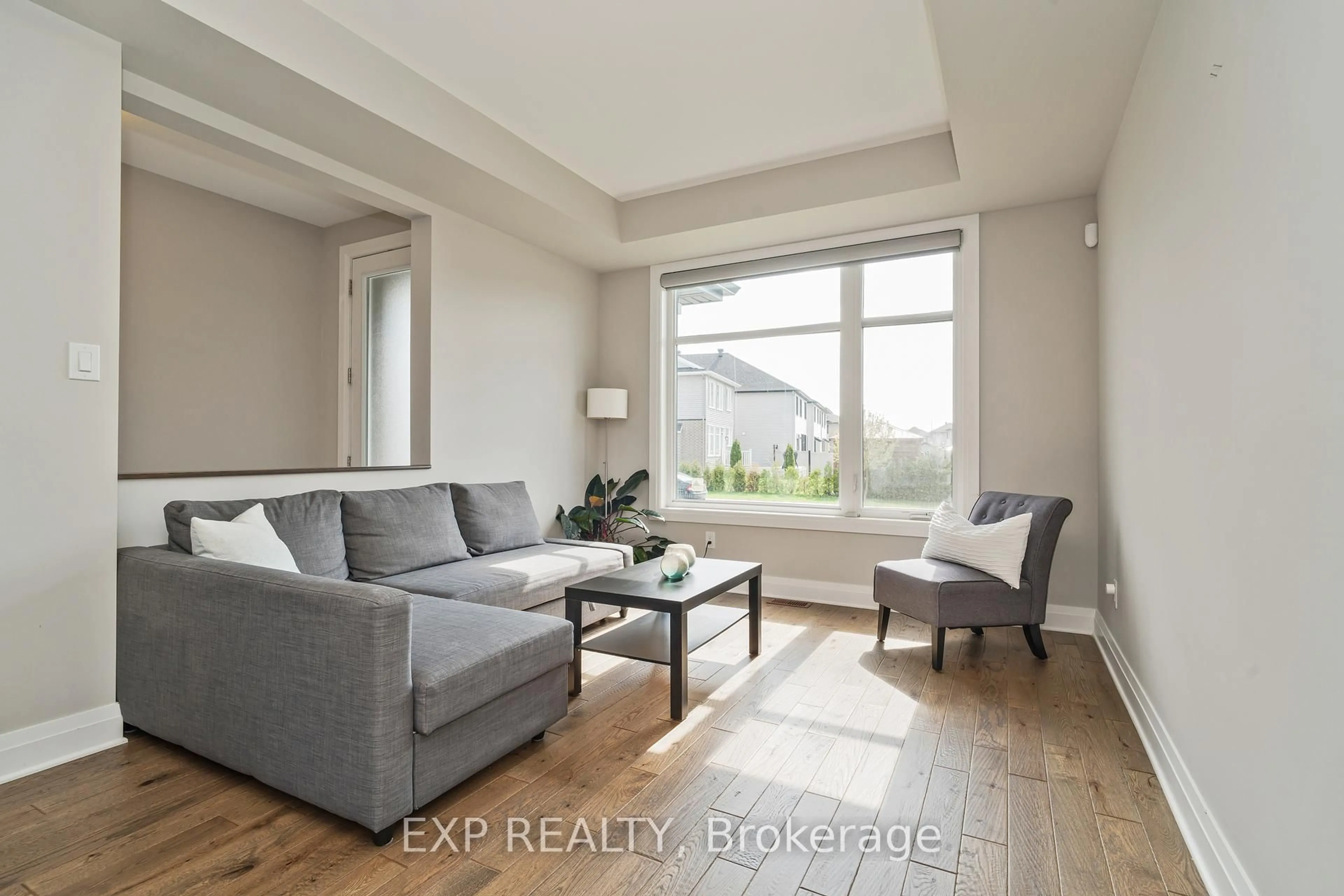 Living room with furniture, wood/laminate floor for 301 SERENADE Cres, Ottawa Ontario K1X 0B9