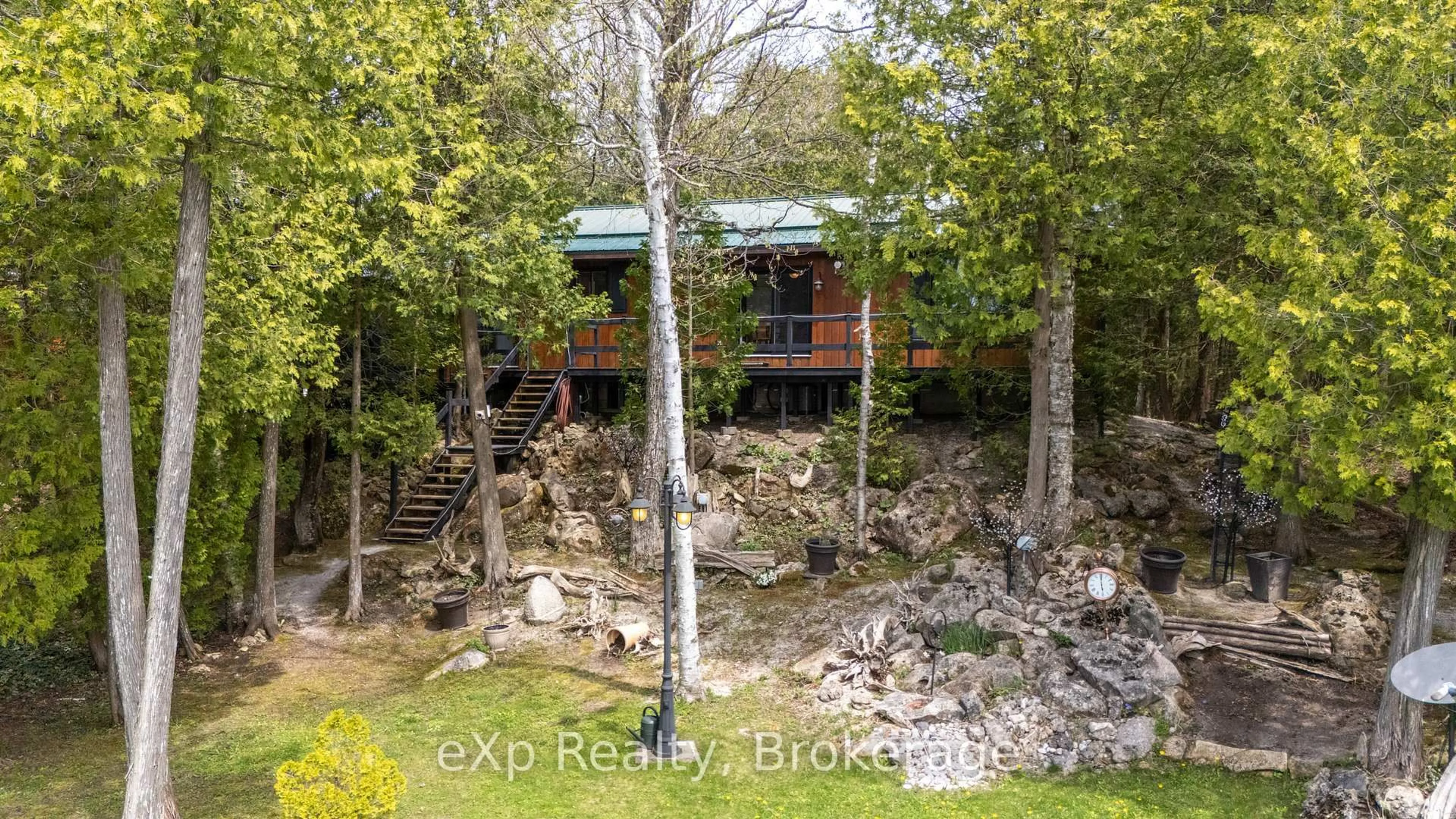 A pic from outside/outdoor area/front of a property/back of a property/a pic from drone, forest/trees view for 37 Hope Dr, Northern Bruce Peninsula Ontario N0H 1Z0