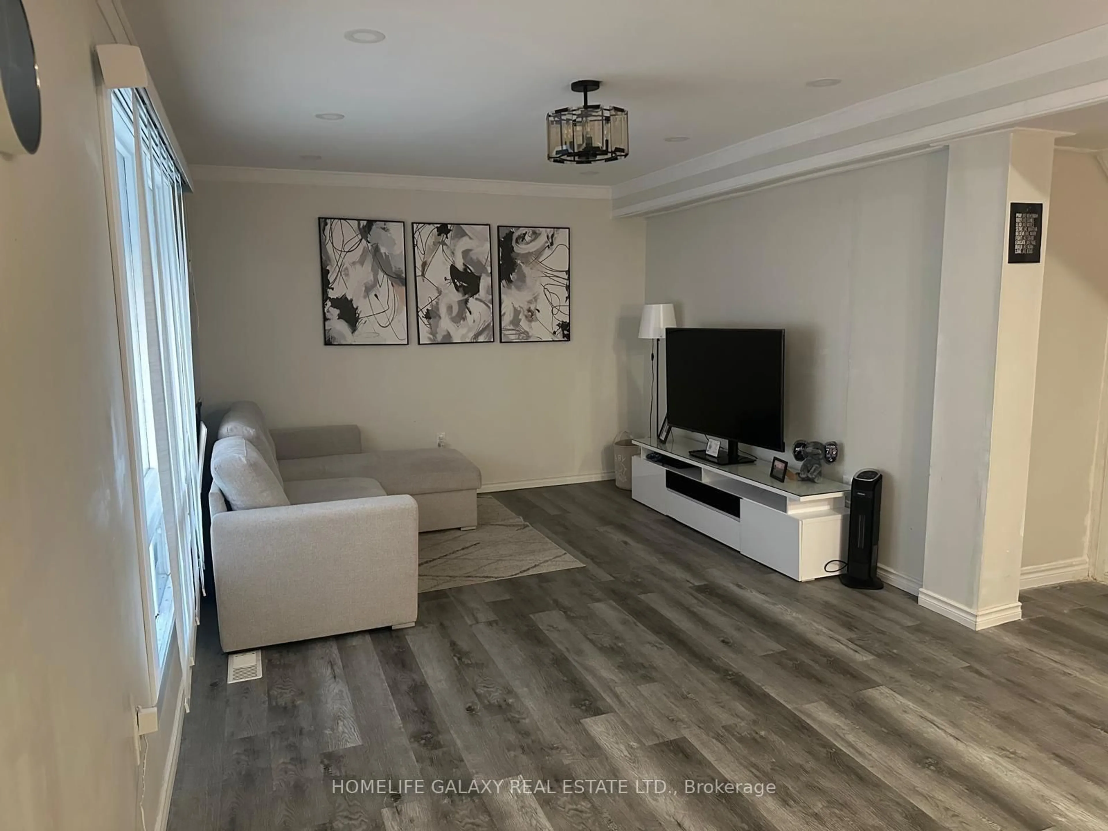 Living room with furniture, wood/laminate floor for 5232 Stamford St, Niagara Falls Ontario L2E 1M9