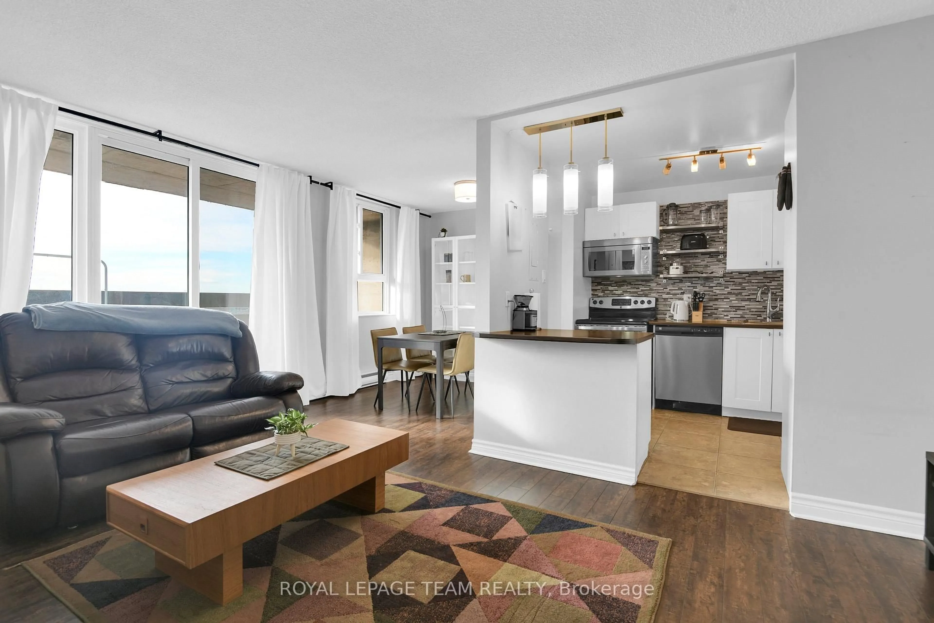 Open concept kitchen, wood/laminate floor for 2000 Jasmine Cres #811, Ottawa Ontario K1J 8K4