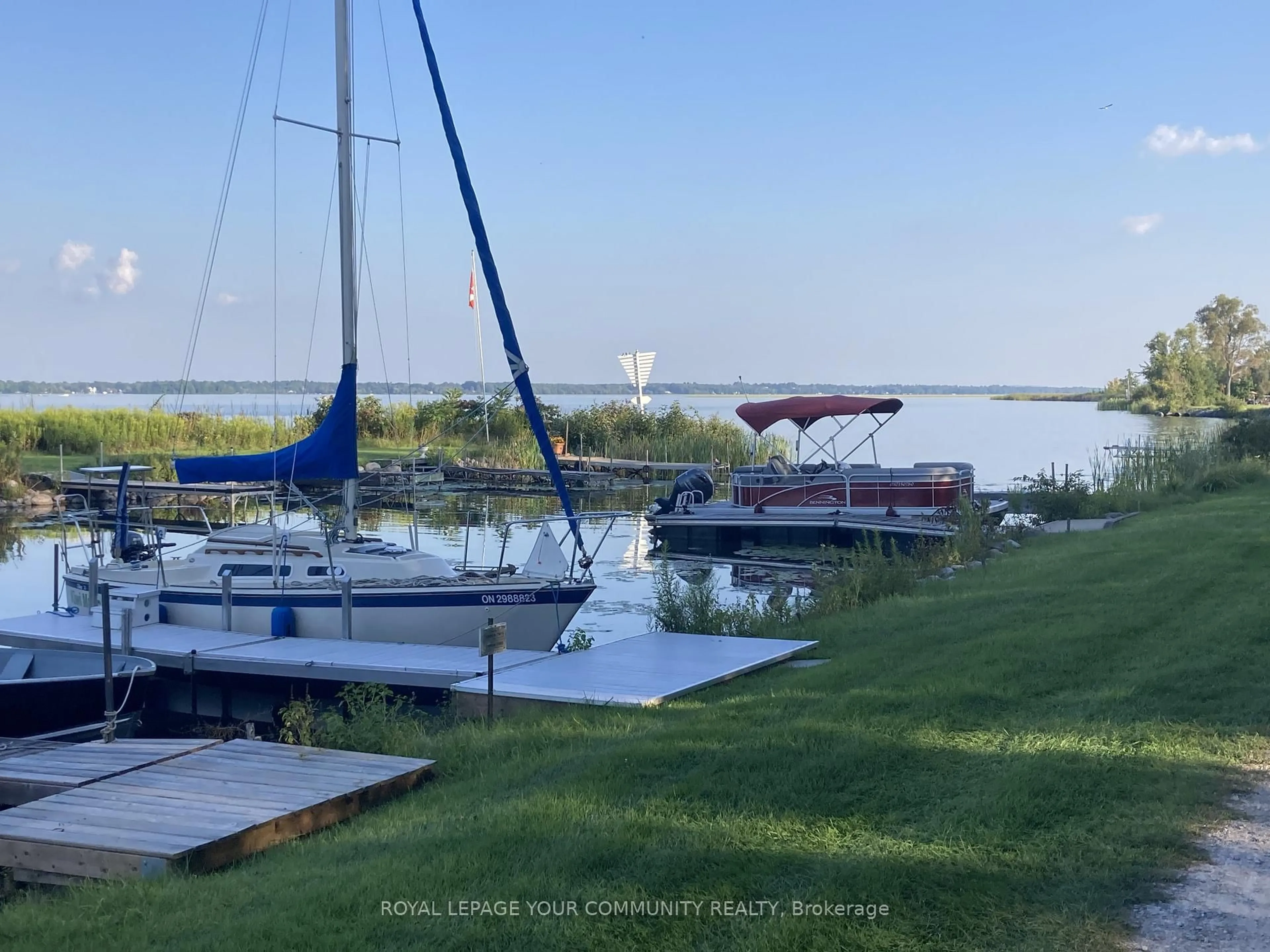 A pic from outside/outdoor area/front of a property/back of a property/a pic from drone, water/lake/river/ocean view for 381 Country Club Circ, Kawartha Lakes Ontario K0M 1A0
