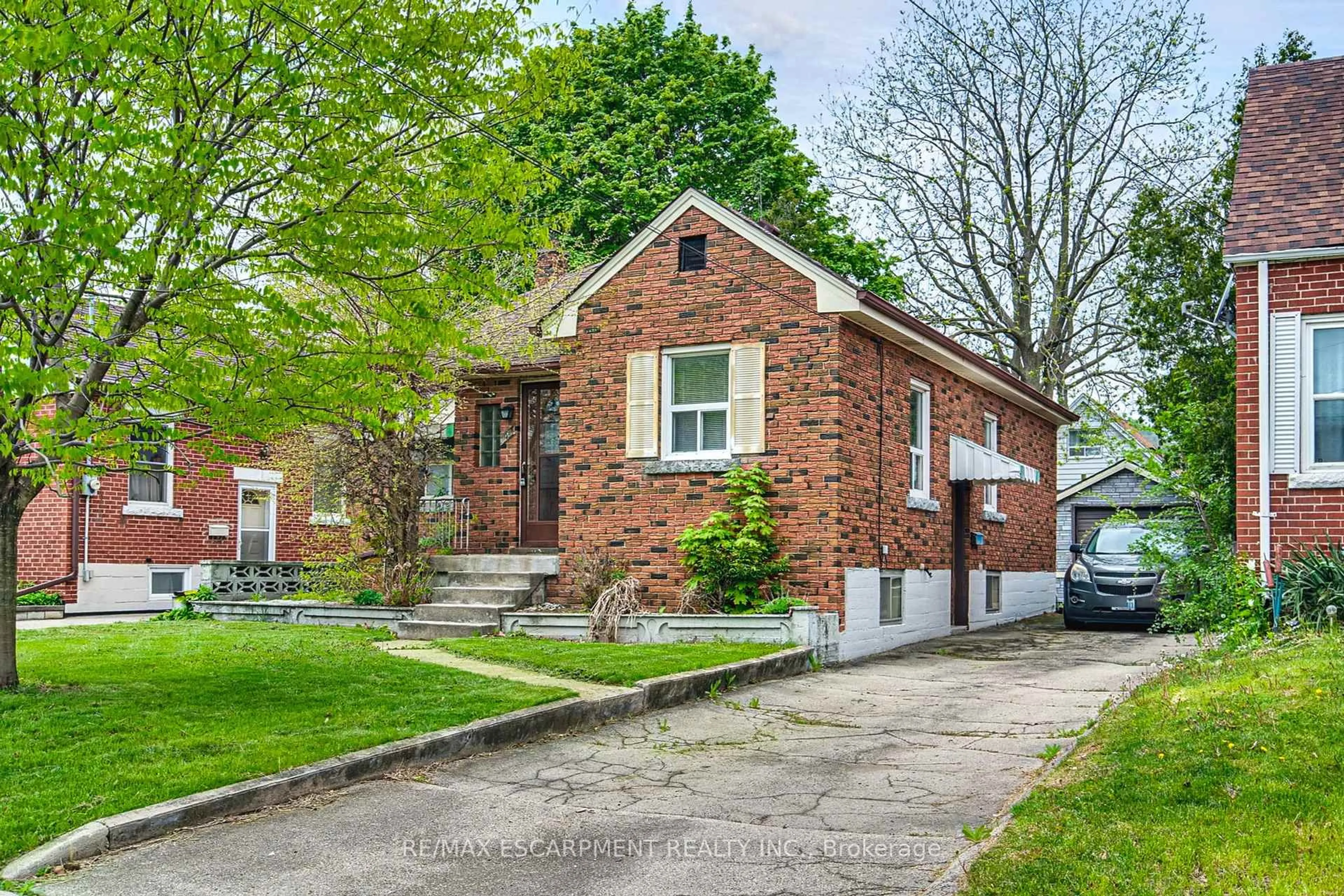 Home with brick exterior material, street for 48 Woodbridge Rd, Hamilton Ontario L8K 3C9