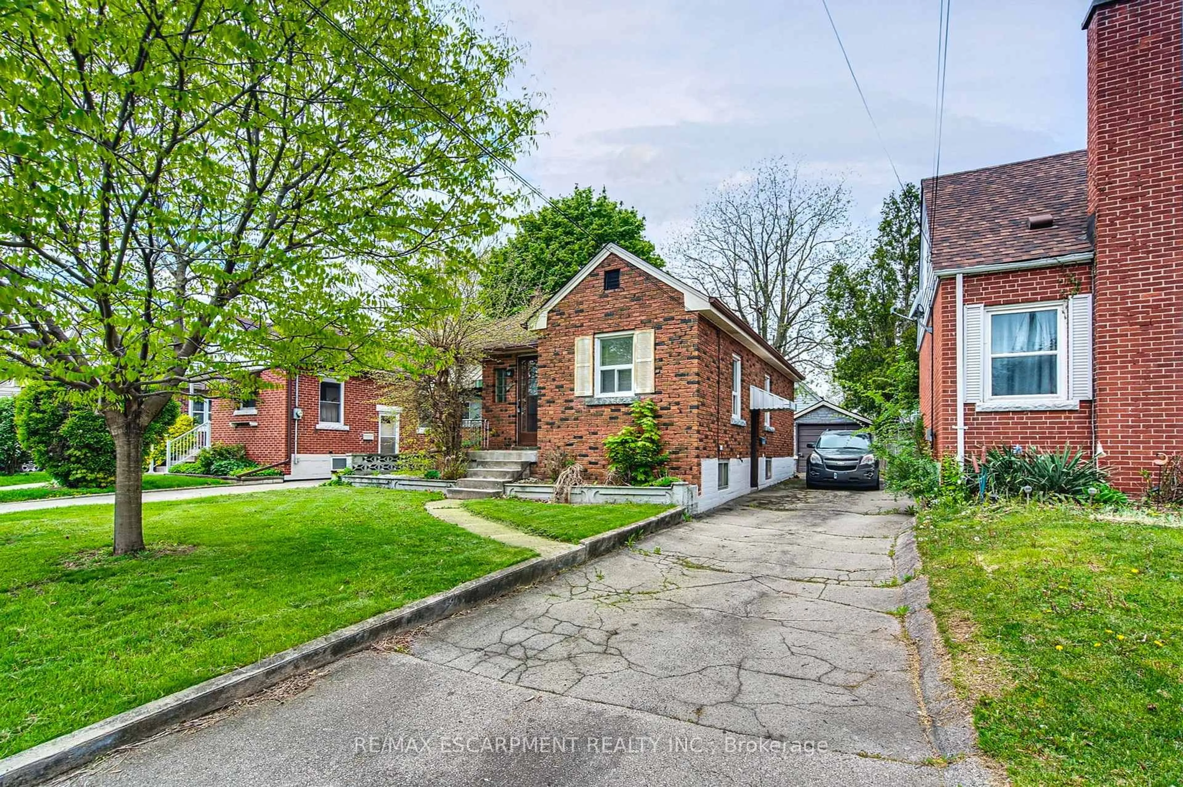 Home with brick exterior material, street for 48 Woodbridge Rd, Hamilton Ontario L8K 3C9