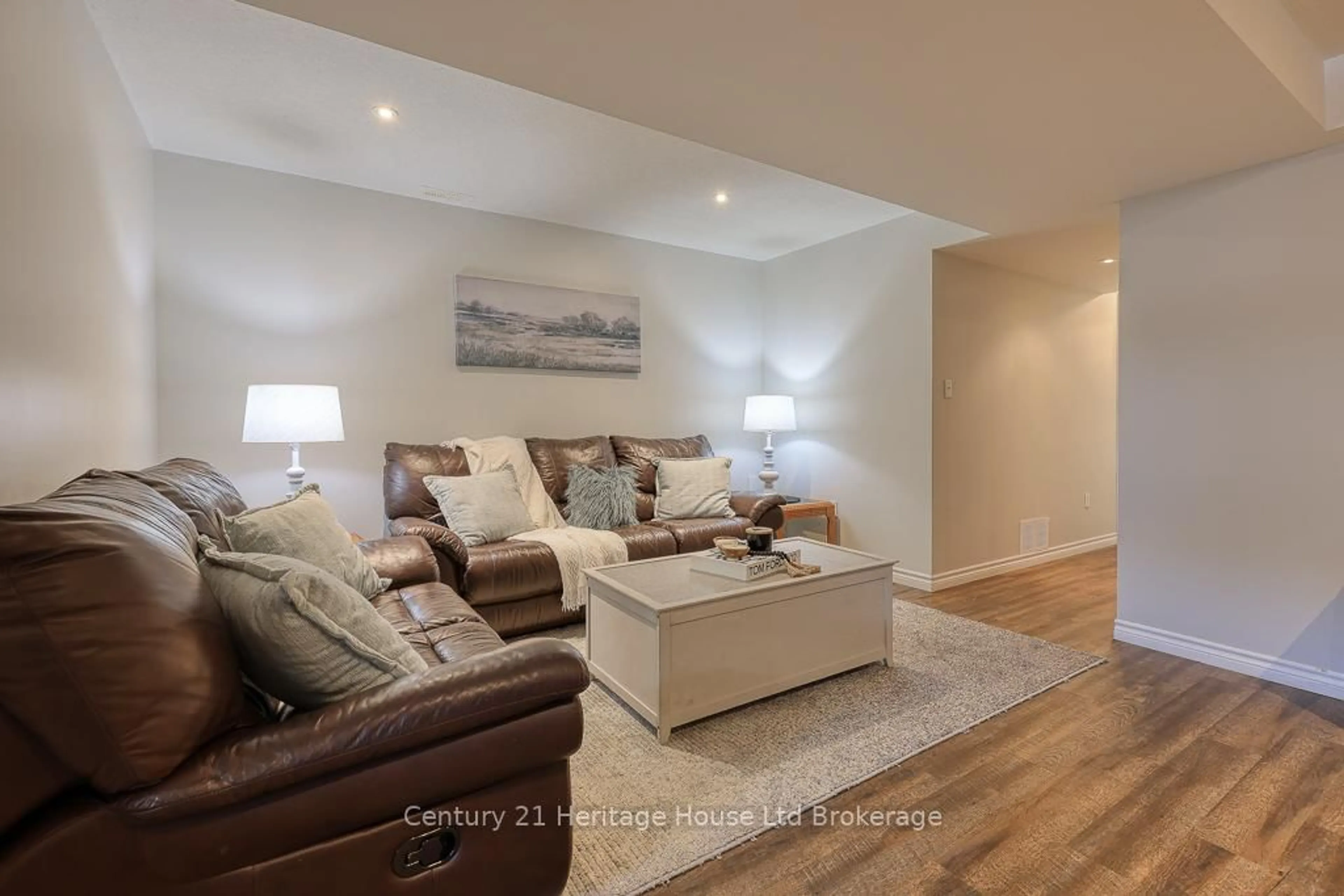 Living room with furniture, wood/laminate floor for 57 Fuller Dr, Ingersoll Ontario N5C 4H4