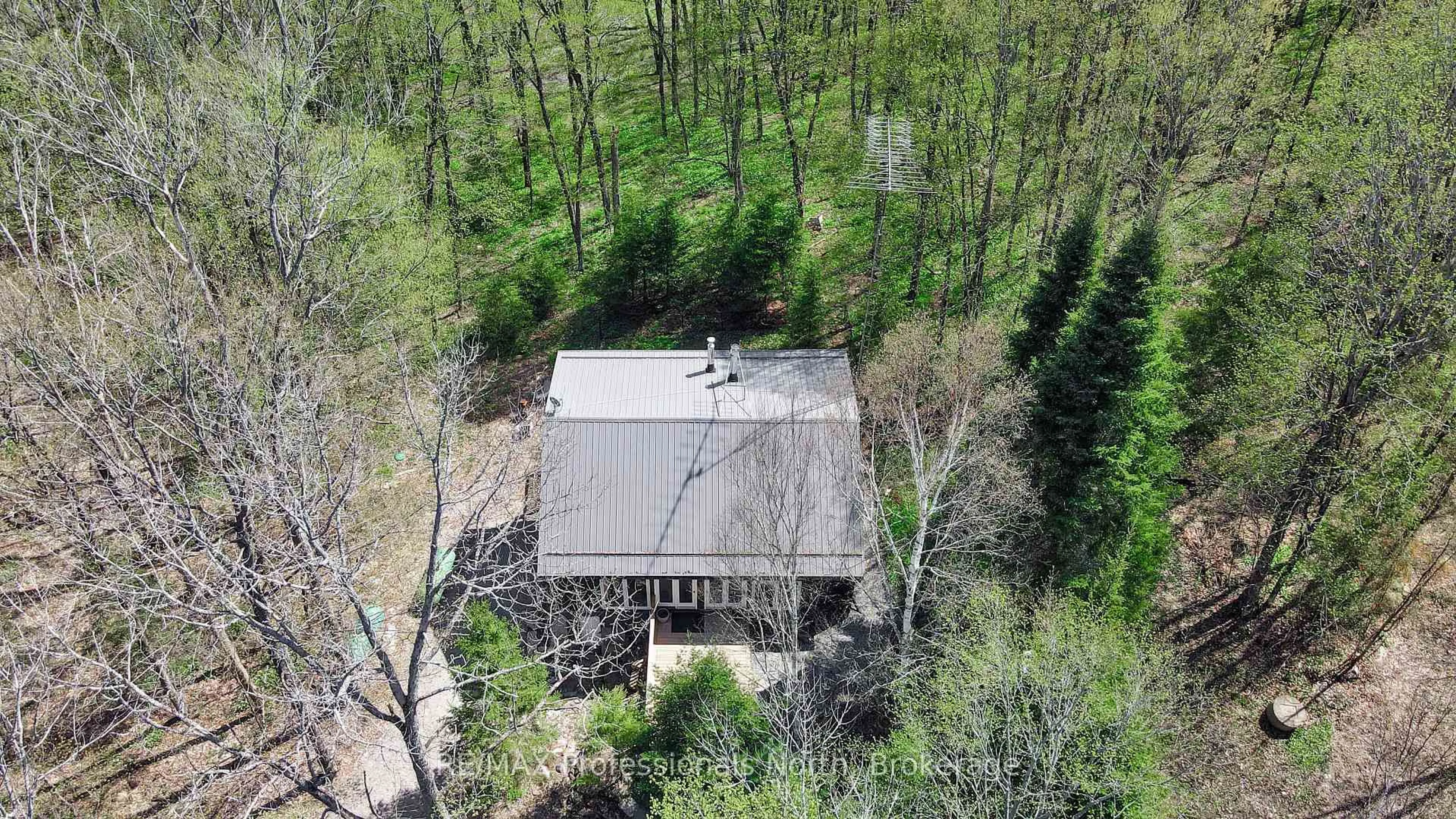 A pic from outside/outdoor area/front of a property/back of a property/a pic from drone, forest/trees view for 1066 Wampum Rd, Dysart et al Ontario K0M 1S0