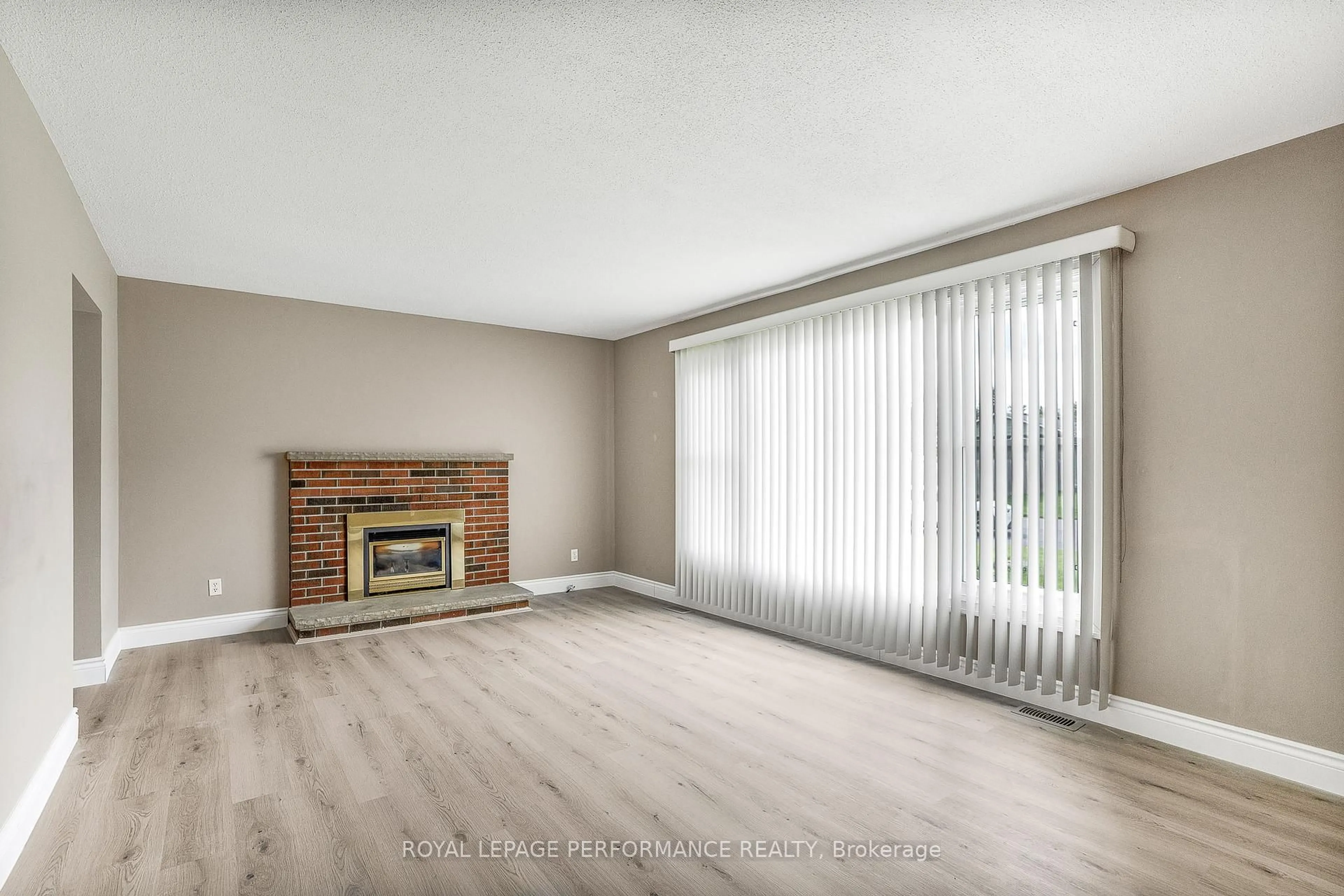 Living room with furniture, wood/laminate floor for 1407 Duford Dr, Orleans Ontario K1E 1E4