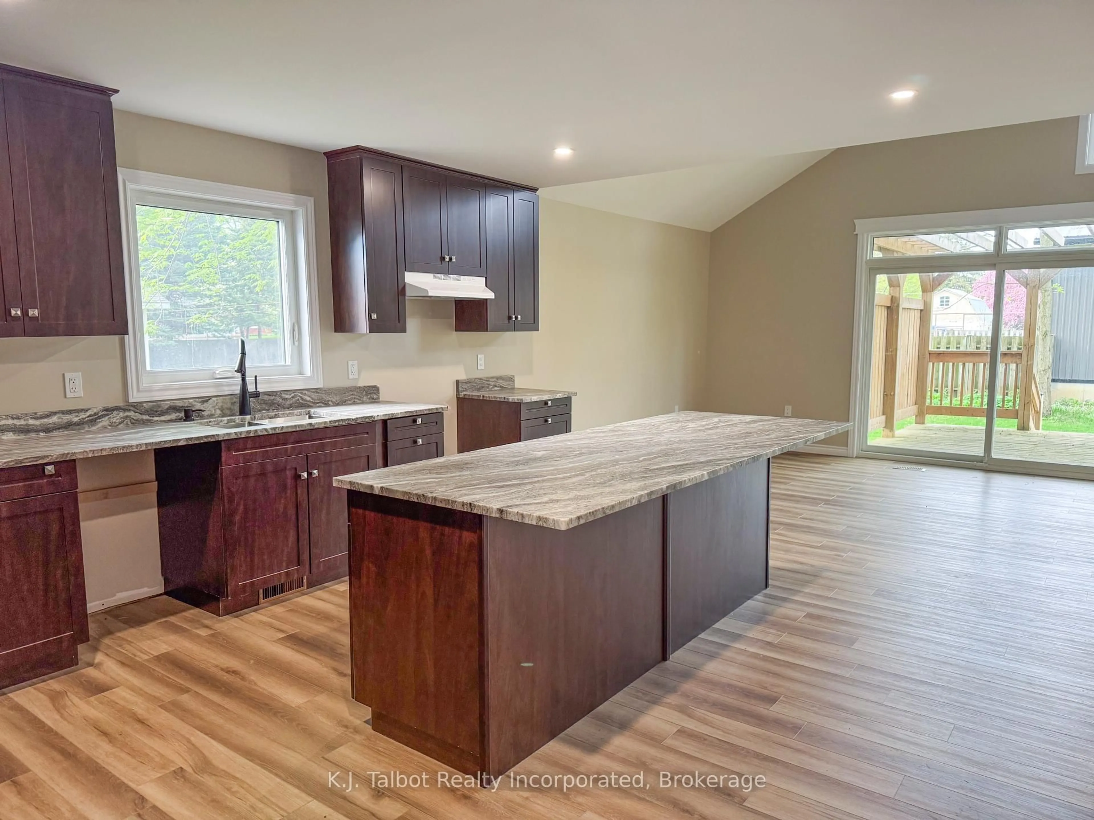 Open concept kitchen, wood/laminate floor for 52 Queen St, Huron East Ontario N0G 1H0